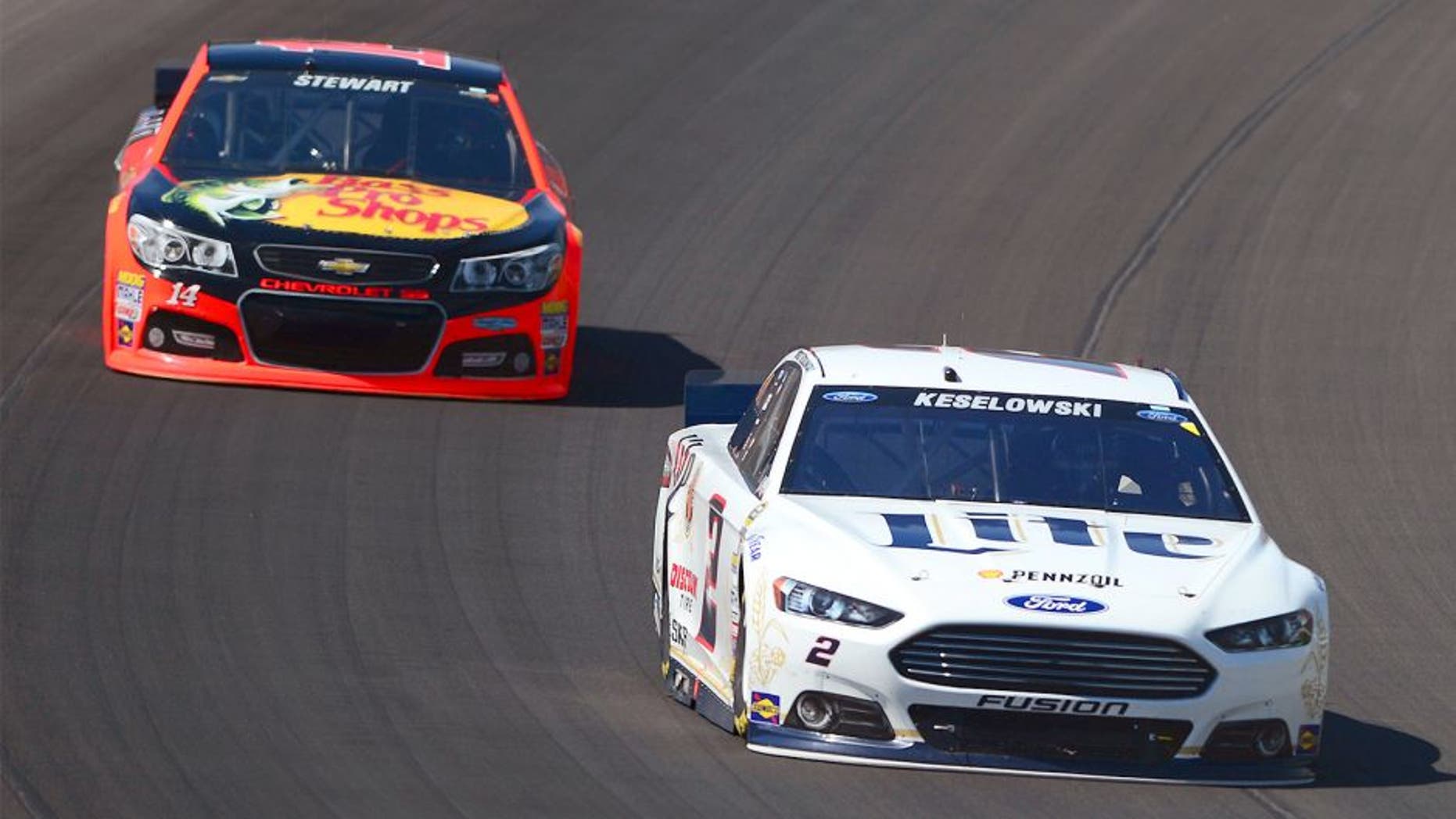 Jun 15, 2014; Brooklyn, MI, USA; NASCAR Sprint Cup Series driver Brad Keselowski leads Tony Stewart during the Quicken Loans 400 at Michigan International Speedway. Mandatory Credit: Andrew Weber-USA TODAY Sports