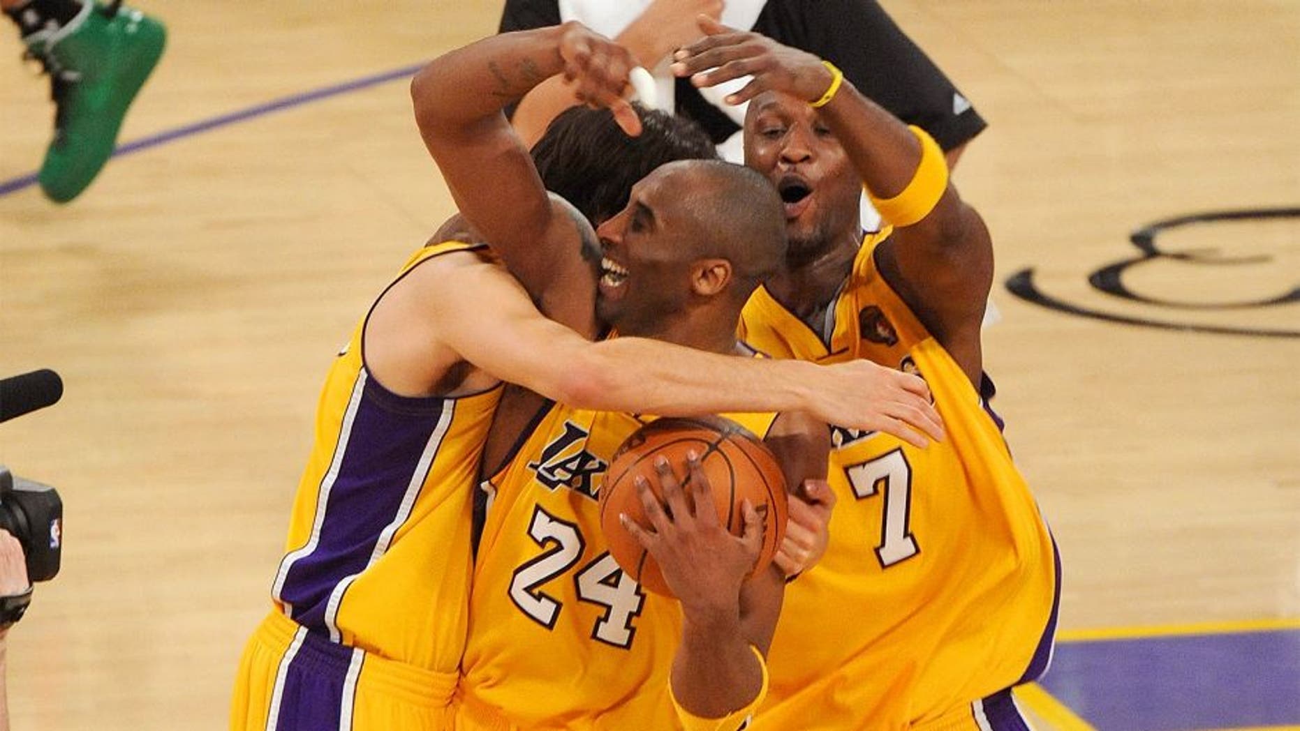 LOS ANGELES, CA - JUNE 17: Kobe Bryant #24, Lamar Odom #7 and Sasha Vujacic #18 of the Los Angeles Lakers celebrate after winning the 2010 NBA Championship 83-79 against the Boston Celtics in Game Seven of the 2010 NBA Finals at Staples Center on June 17, 2010 in Los Angeles, California. NOTE TO USER: User expressly acknowledges and agrees that, by downloading and/or using this Photograph, user is consenting to the terms and conditions of the Getty Images License Agreement. (Photo by Lisa Blumenfeld/Getty Images) *** Local Caption *** Kobe Bryant;Sasha Vujacic;Lamar Odom