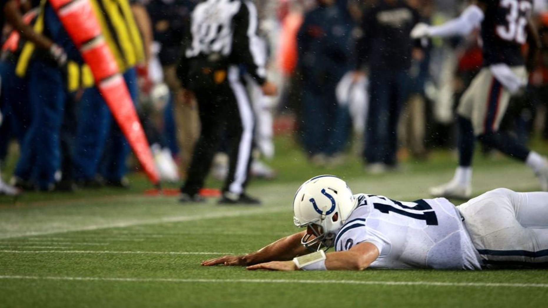 FOXBOROUGH, MA - JANUARY 18: Colts quarterback Andrew Luck gets hit by Patriots Chandler Jones, not pictured, in the fourth quarter at Gillette Stadium Sunday, January 18, 2015. AFC Championship Game between the New England Patriots and the Indianapolis Colts. (Photo by Jim Davis/The Boston Globe via Getty Images)