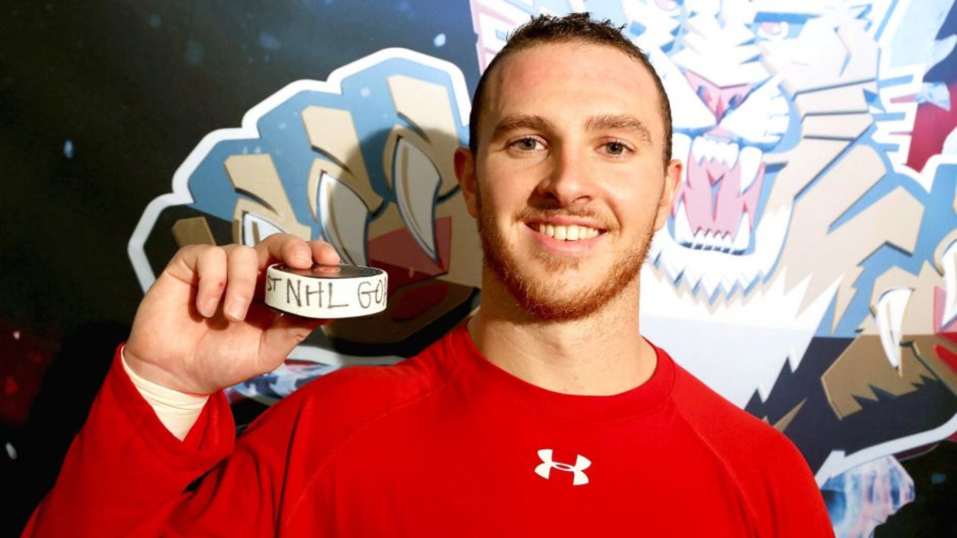 RALEIGH, NC - OCTOBER 13: Connor Brickley #86 of the Florida Panthers poses with the puck after scoring his first NHL goal following a game against the Carolina Hurricanes at PNC Arena on October 13, 2015 in Raleigh, North Carolina. (Photo by Gregg Forwerck/NHLI via Getty Images)