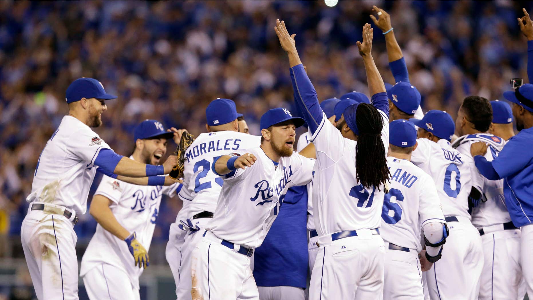 Oct. 14, 2015: Kansas City Royals' Ben Zobrist, left, celebrates with starting pitcher Johnny Cueto (47) after their 7-2 win over the Houston Astros in Game 5 in baseball's American League Division Series.