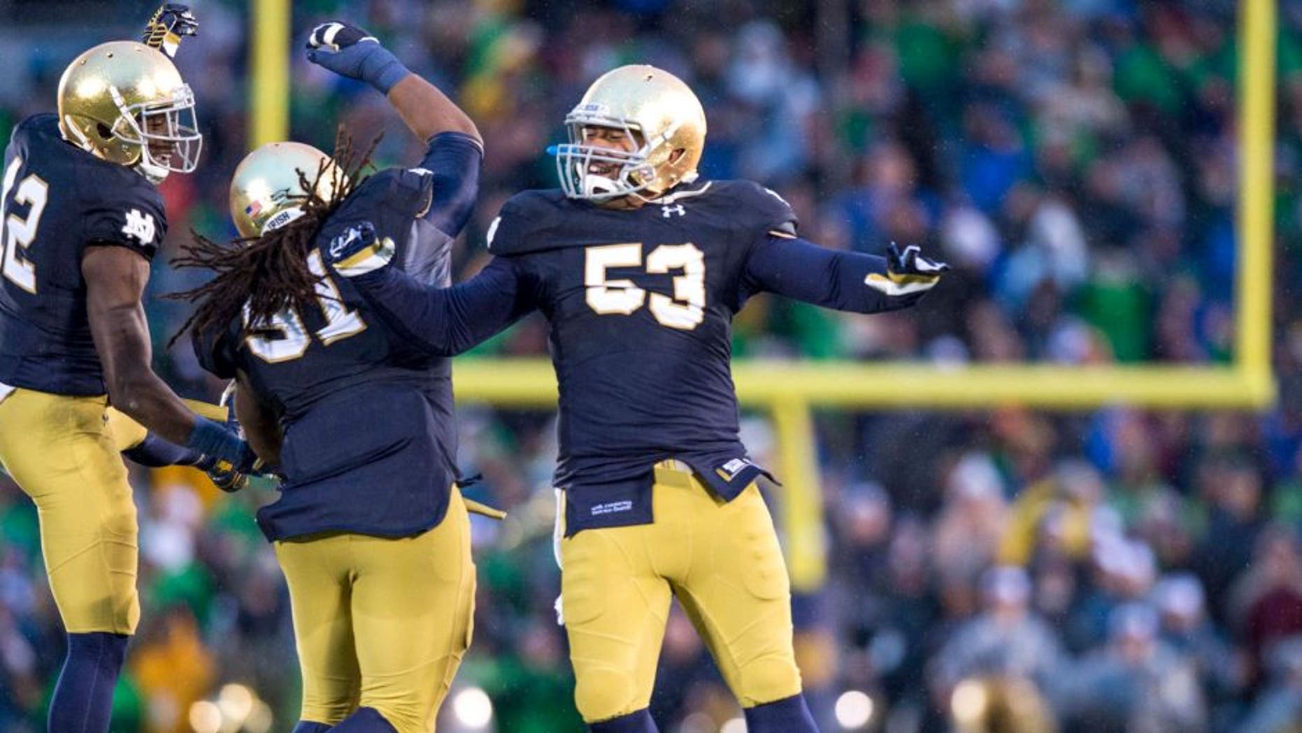 Notre Dame Fighting Irish cornerback Devin Butler (12) defensive lineman Sheldon Day (91) and defensive lineman Justin Utupo (53) react after Notre Dame defeated the Stanford Cardinal 17-14 at Notre Dame Stadium. Mandatory Credit: Matt Cashore-USA TODAY Sports
