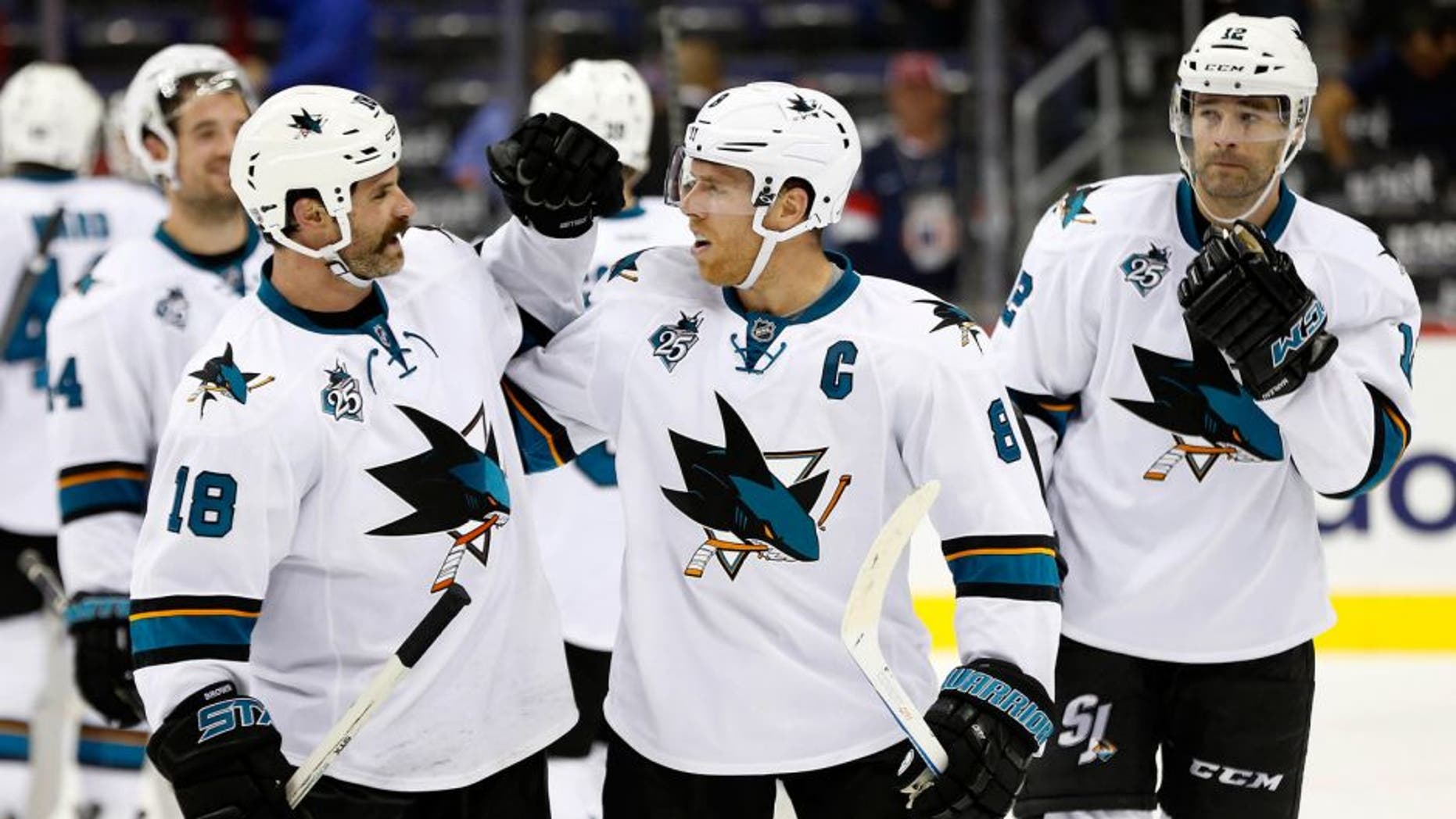 Oct 13, 2015; Washington, DC, USA; San Jose Sharks right wing Mike Brown (18) celebrates with Sharks center Joe Pavelski (8) after their game against the Washington Capitals at Verizon Center. The Sharks won 5-0. Mandatory Credit: Geoff Burke-USA TODAY Sports