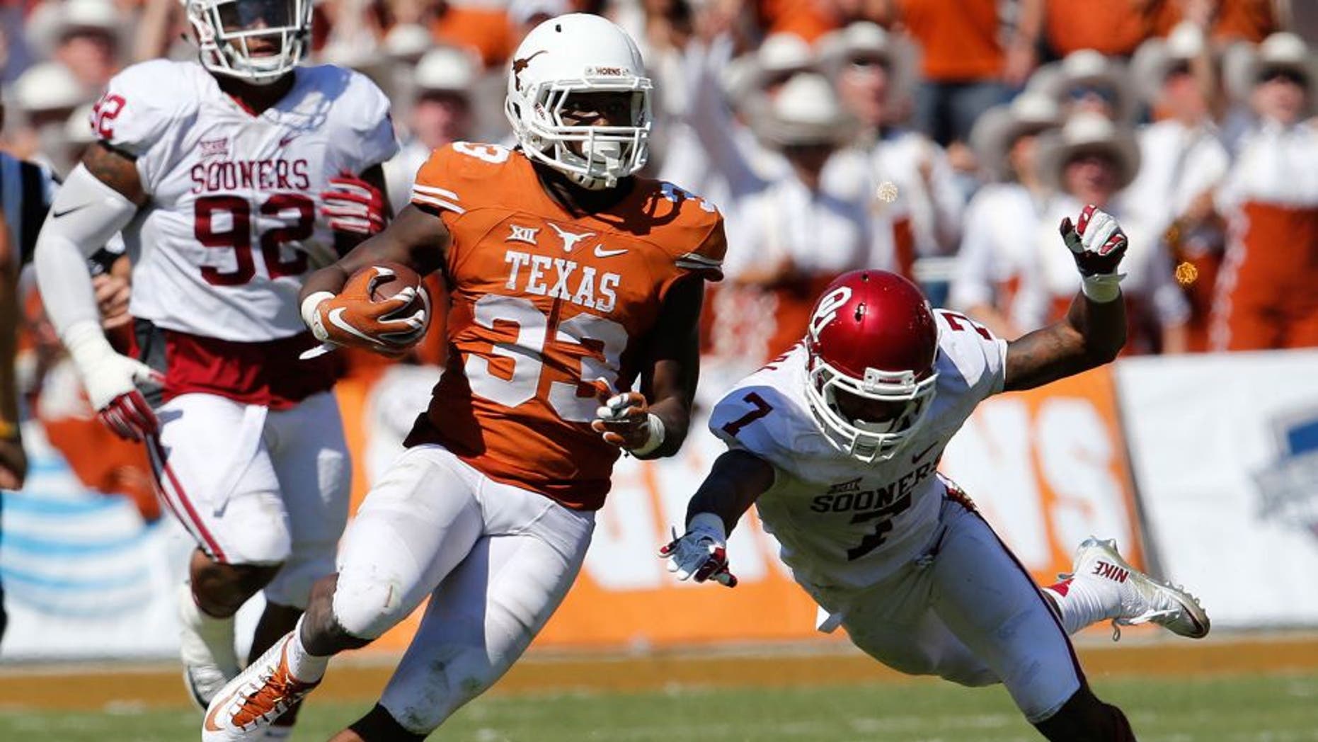 Oct 10, 2015; Dallas, TX, USA; Texas Longhorns running back D'Onta Foreman (33) runs with the ball in the third quarter against Oklahoma Sooners cornerback Jordan Thomas (7) during Red River rivalry at Cotton Bowl Stadium. Mandatory Credit: Matthew Emmons-USA TODAY Sports