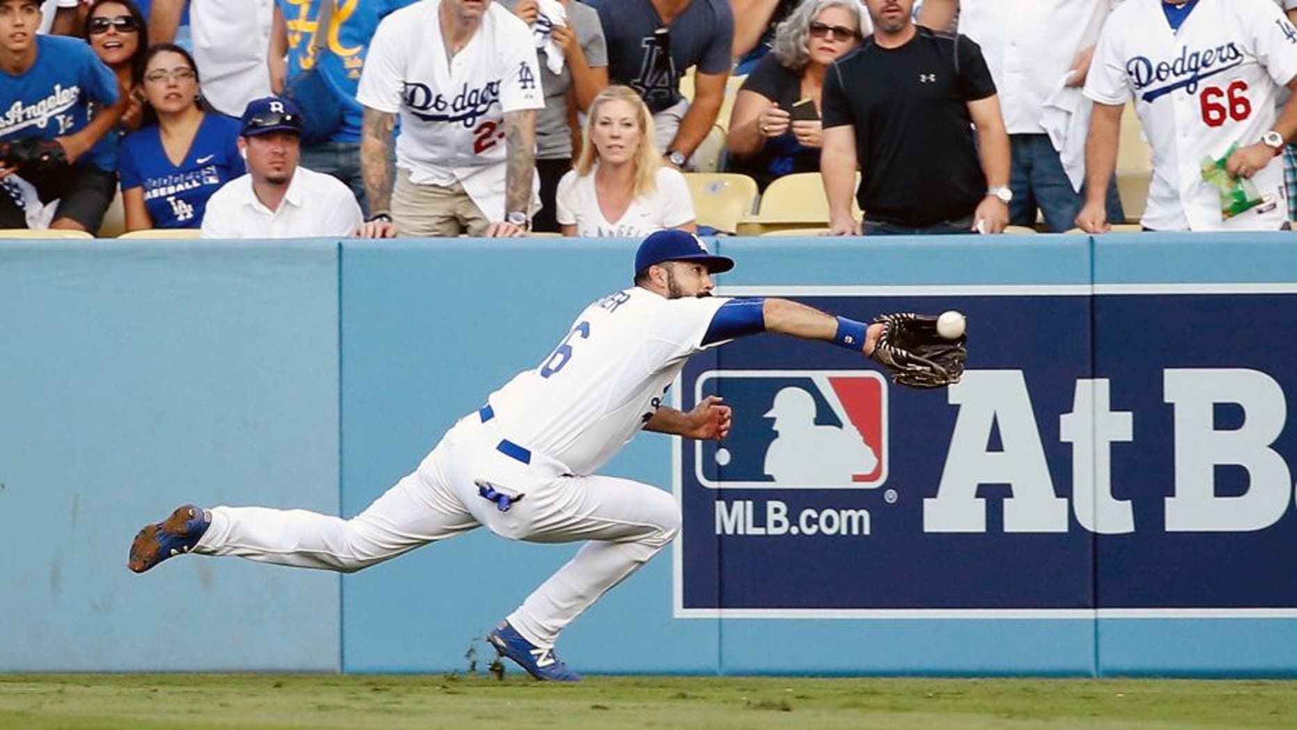 LOS ANGELES, CA - OCTOBER 15: Andre Ethier #16 of the Los Angeles Dodgers makes a diving catch on a ball hit by Michael Conforto #30 of the New York Mets in the second inning in game five of the National League Division Series at Dodger Stadium on October 15, 2015 in Los Angeles, California. (Photo by Sean M. Haffey/Getty Images)