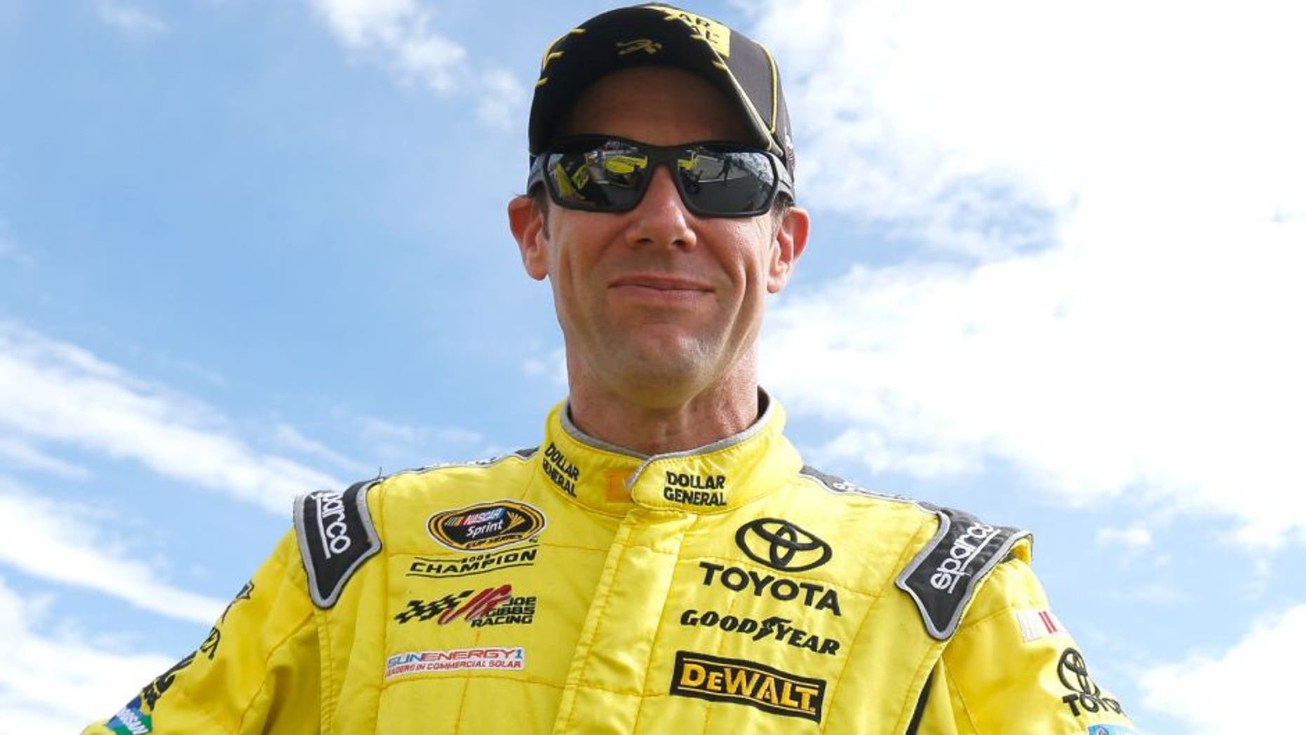 Matt Kenseth, driver of the #20 Dollar General Toyota, stands on the grid during qualifying for the NASCAR Sprint Cup Series Axalta "We Paint Winners" 400 at Pocono Raceway on June 5, 2015 in Long Pond, Pennsylvania.