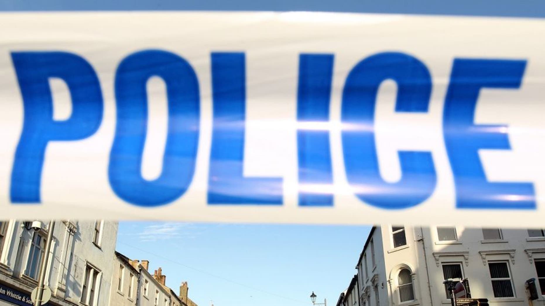 WHITEHAVEN, ENGLAND - JUNE 2: Duke Street in Whitehaven is cordoned off to the public with police-tape for a scene of a murder caused by gunman Derrick Bird on June 2, 2010 in Whitehaven, England. 12 people have been shot dead and a further 25 people injured after a 52 year old man named as Derrick Bird went on a rampage with a shotgun in Cumbria before killing himself. (Photo by Oli Scarff/Getty Images)