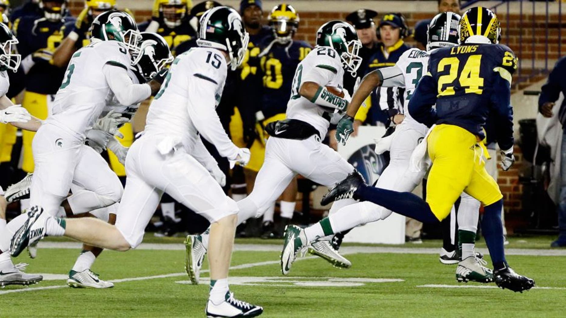 Michigan State defensive back Jalen Watts-Jackson (20) runs towards the end zone after recovering a fumbled snap on a punt in the closing seconds of the second half of an NCAA college football game, Saturday, Oct. 17, 2015, in Ann Arbor, Mich. Watts-Jackson lumbered 38 yards for a touchdown on the final play of the game, giving No. 7 Michigan State a shocking 27-23 win over No. 12 Michigan(AP Photo/Carlos Osorio)