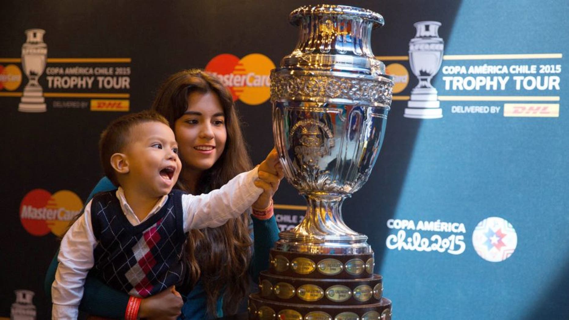 MEXICO CITY, MEXICO - MAY 21: A child touches the Copa America's Trophy during the Copa America Trophy Tour at Papalote Museo del Niâ±o in Mexico City, Mexico on May 21, 2015. Copa America Tournament will be held in Chile from 11 June to 4 July. (Photo by Daniel Cardenas/Anadolu Agency/Getty Images)