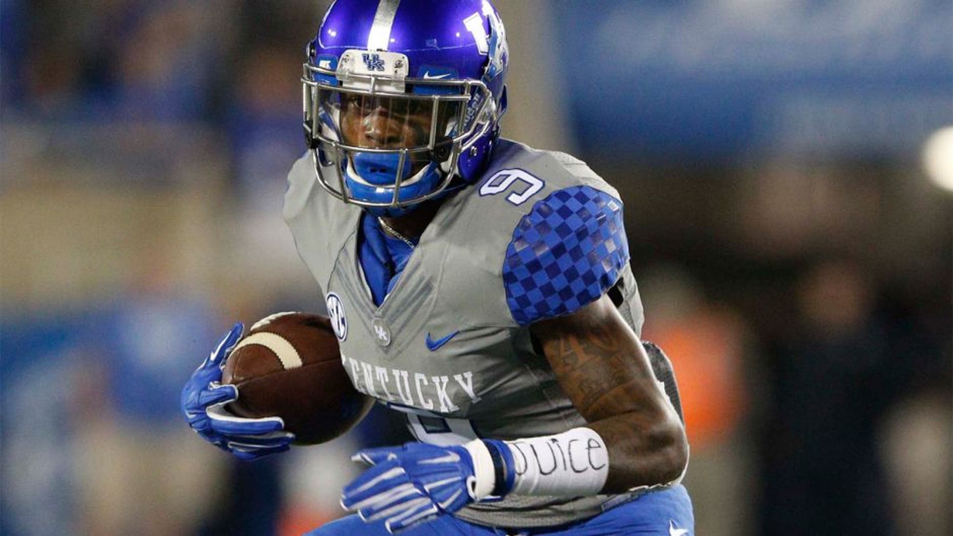 Sep 26, 2015; Lexington, KY, USA; Kentucky Wildcats wide receiver Garrett Johnson (9) runs the ball against the Missouri Tigers in the first half at Commonwealth Stadium. Mandatory Credit: Mark Zerof-USA TODAY Sports