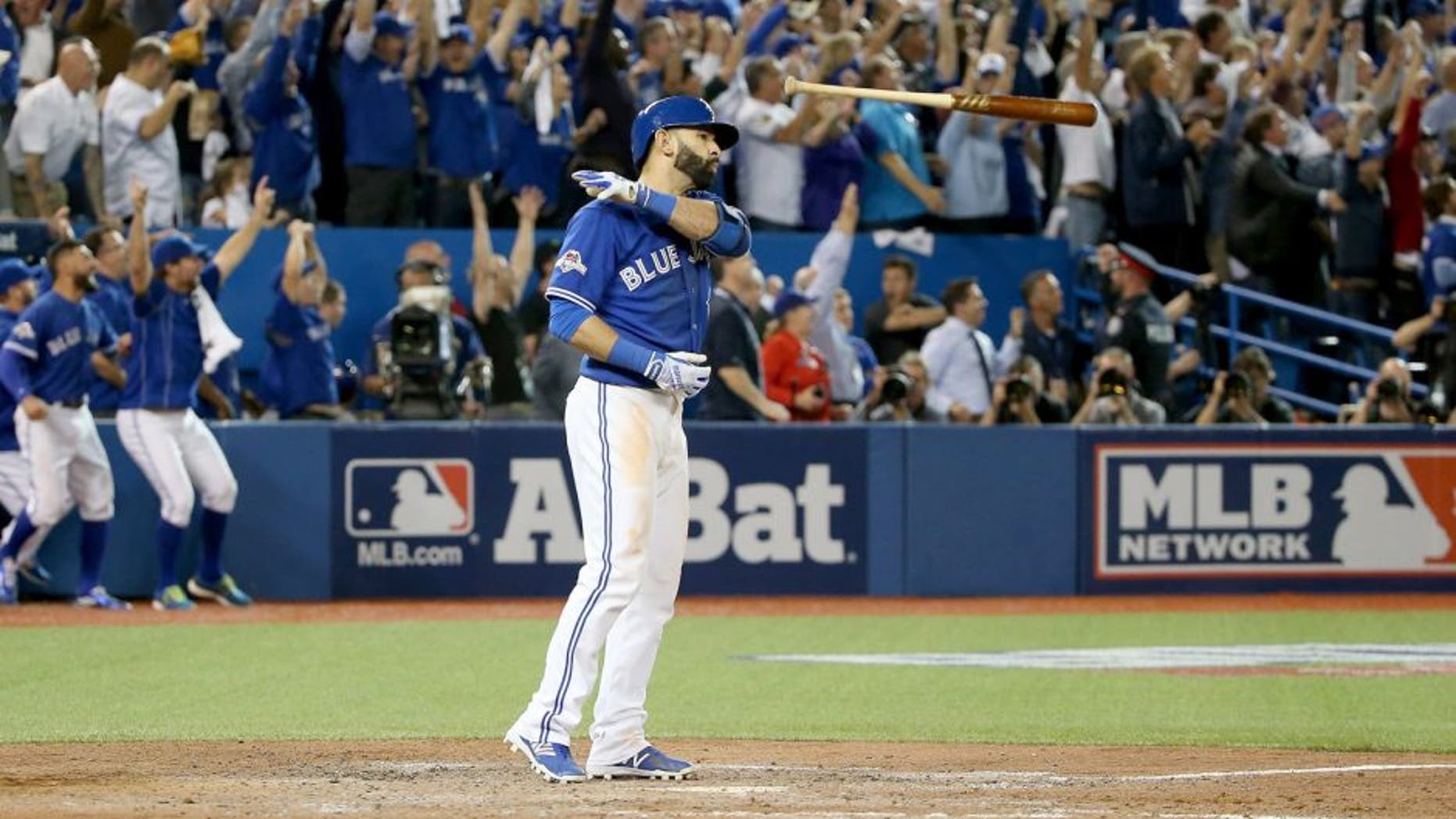 TORONTO, ON - OCTOBER 14: Jose Bautista #19 of the Toronto Blue Jays flips his bat up in the air after he hits a three-run home run in the seventh inning against the Texas Rangers in game five of the American League Division Series at Rogers Centre on October 14, 2015 in Toronto, Canada. (Photo by Tom Szczerbowski/Getty Images)