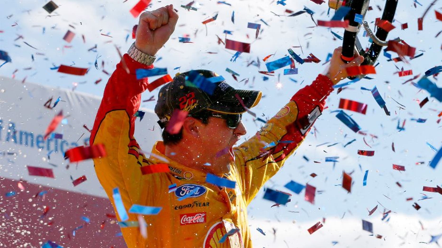 CHARLOTTE, NC - OCTOBER 11: Joey Logano, driver of the #22 Shell Pennzoil Ford, celebrates in Victory Lane after winning the NASCAR Sprint Cup Series Bank of America 500 at Charlotte Motor Speedway on October 11, 2015 in Charlotte, North Carolina. (Photo by Jonathan Ferrey/Getty Images)