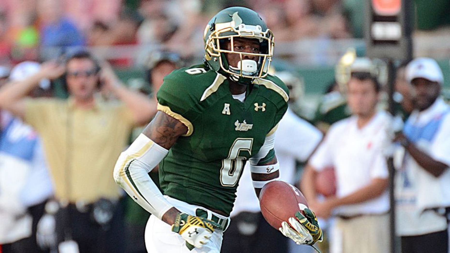 Sep 13, 2014; Tampa, FL, USA; South Florida Bulls defensive back Lamar Robbins (6) returns an interception for a touchdown in the second half against the North Carolina State Wolfpack at Raymond James Stadium. Mandatory Credit: Jonathan Dyer-USA TODAY Sports