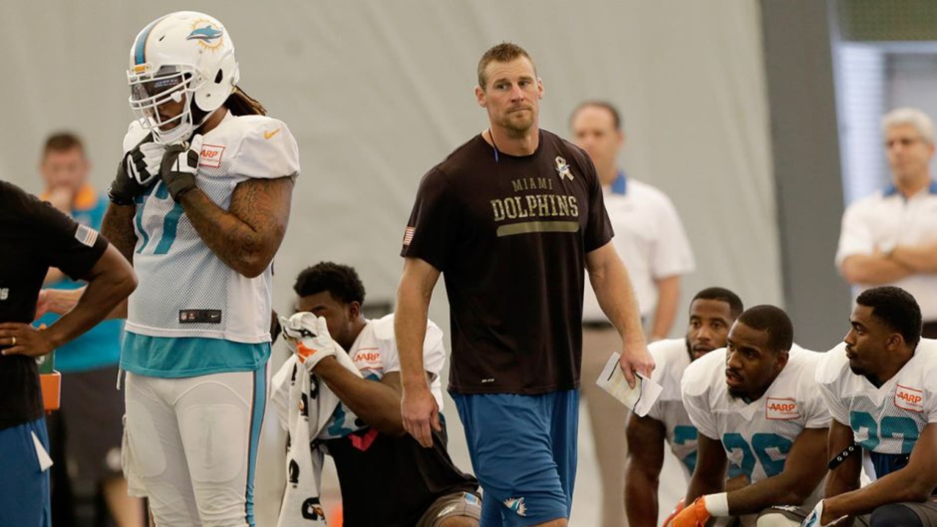 Miami Dolphins interim coach Dan Campbell walks on the field during NFL football practice in Davie, Fla., Wednesday, Oct. 7, 2015. (AP Photo/Alan Diaz)