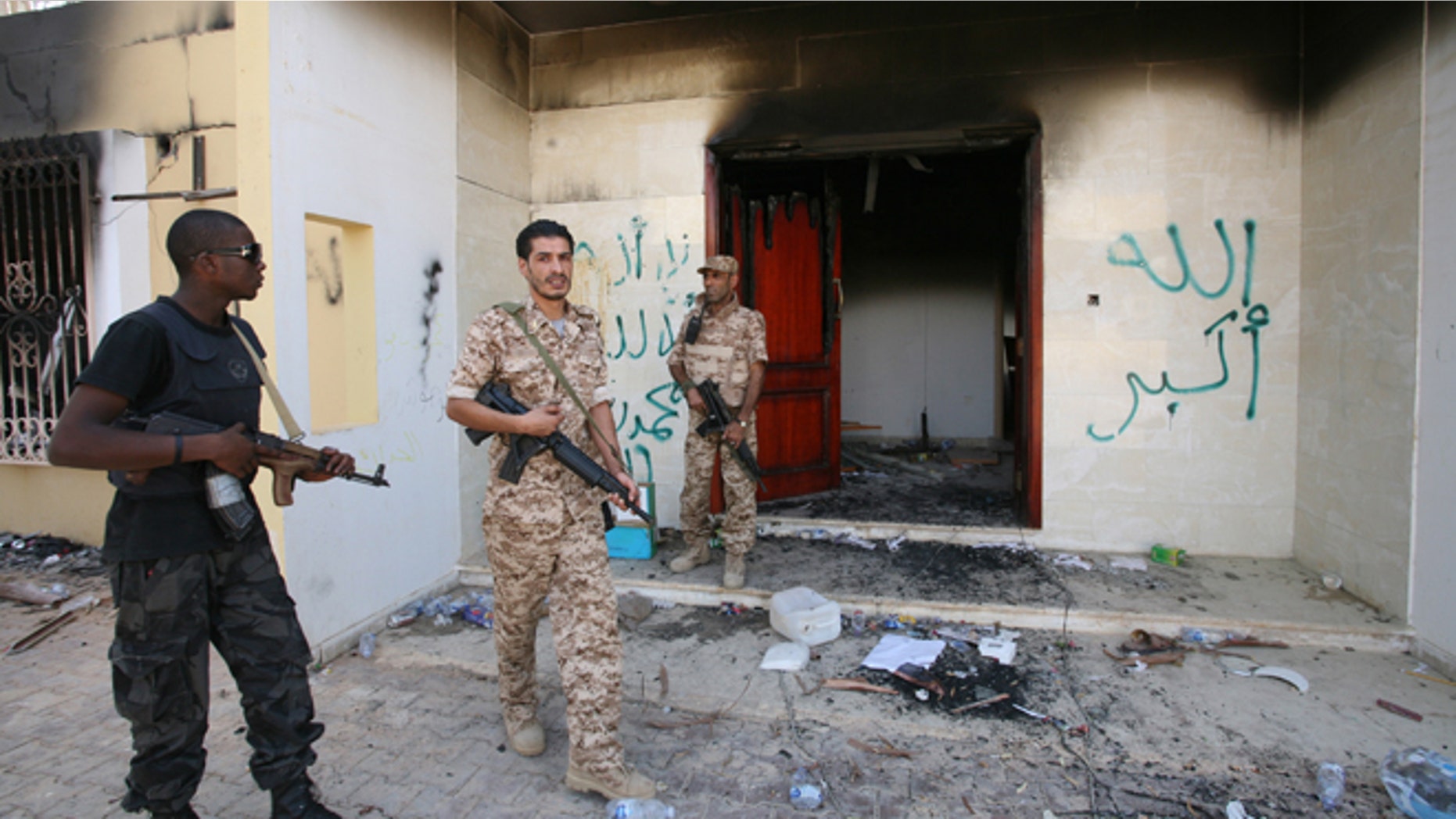 File: Sept. 14, 2012: Libyan military guards check one of the burnt out buildings at the U.S. Consulate in Benghazi, Libya, during a visit by Libyan President Mohammed el-Megarif to express sympathy for the death of American ambassador to Libya Chris Stevens and his colleagues in the Sept. 11, 2012 attack.