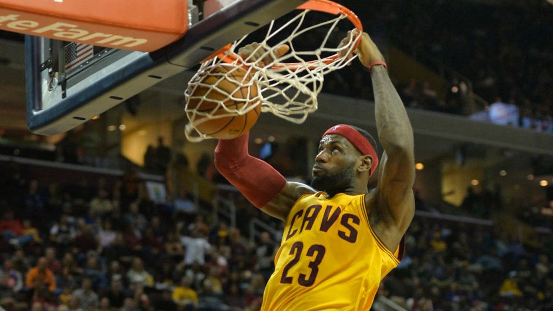 Oct 17, 2014; Cleveland, OH, USA; Cleveland Cavaliers forward LeBron James (23) dunks in the third quarter against the Dallas Mavericks at Quicken Loans Arena. After a video review by officials, the basket was taken away due to a foul before the score. Mandatory Credit: David Richard-USA TODAY Sports