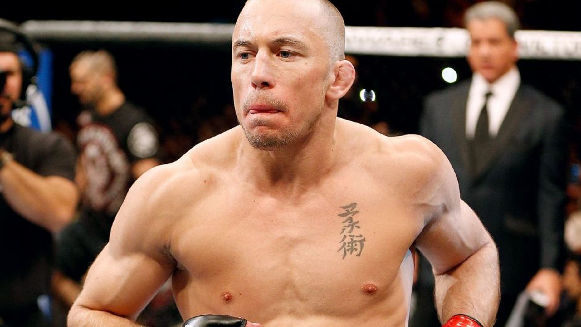 LAS VEGAS, NV - NOVEMBER 16: Georges St-Pierre walks into the Octagon to face Johny Hendricks in their UFC welterweight championship bout during the UFC 167 event inside the MGM Grand Garden Arena on November 16, 2013 in Las Vegas, Nevada. (Photo by Josh Hedges/Zuffa LLC/Zuffa LLC via Getty Images)