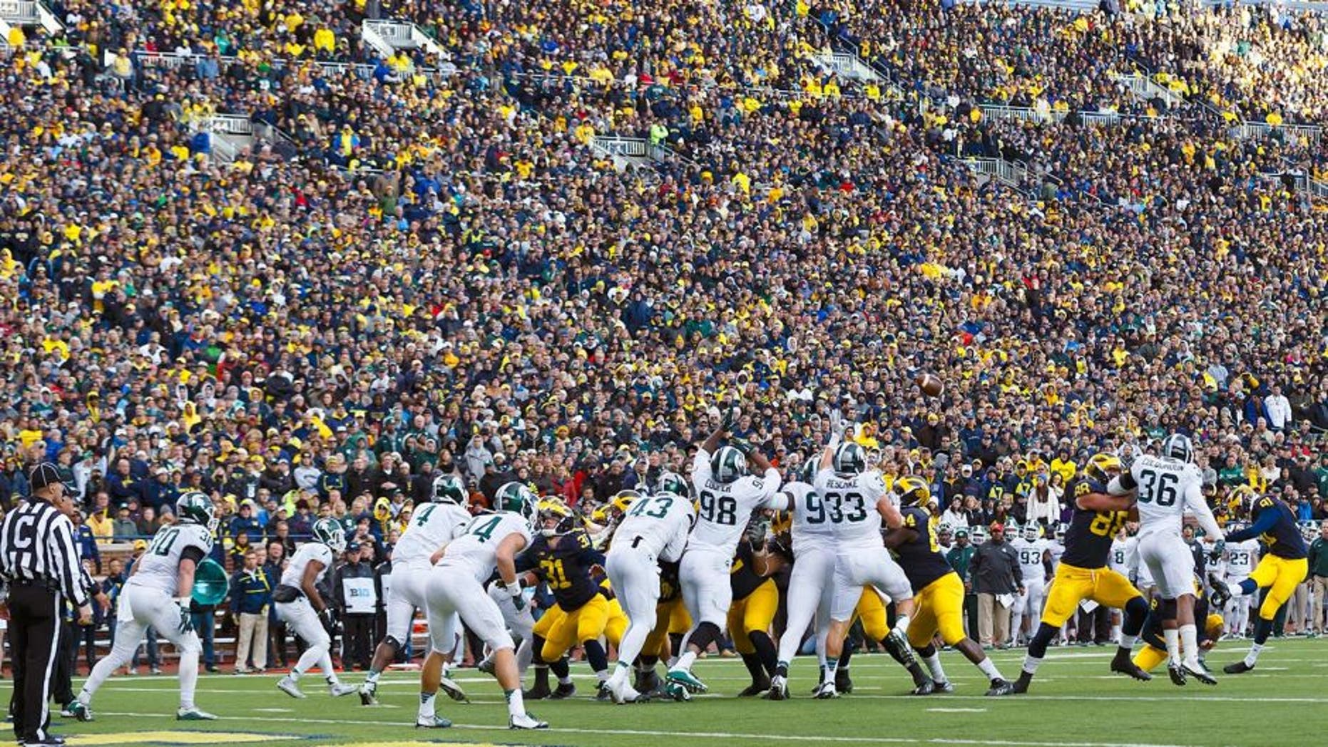 Oct 17, 2015; Ann Arbor, MI, USA; Michigan Wolverines place kicker Kenny Allen (91) kicks a field goal in the third quarter against the Michigan State Spartans at Michigan Stadium. Mandatory Credit: Rick Osentoski-USA TODAY Sports