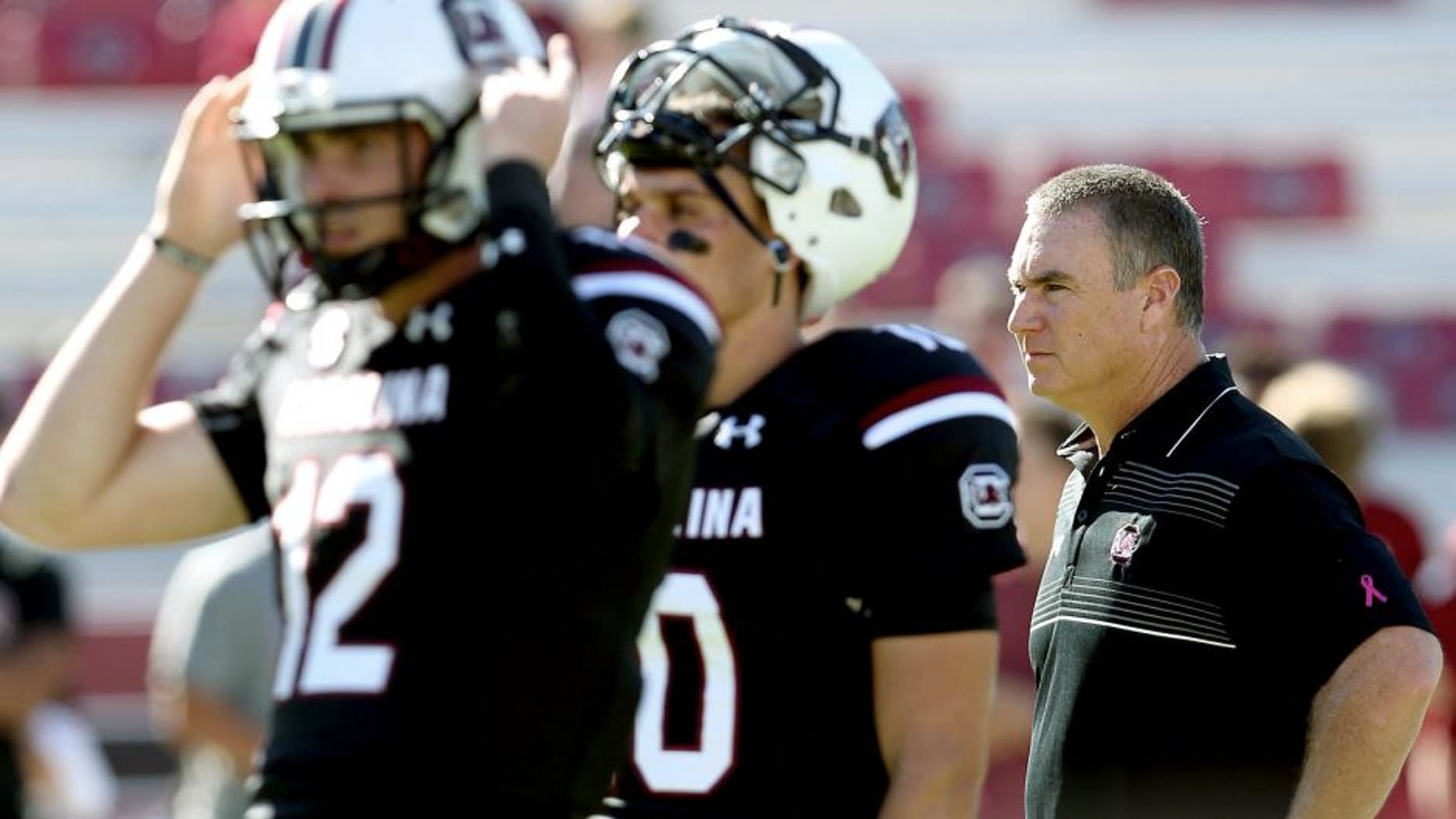 COLUMBIA, SC - OCTOBER 17: Interim head coach Shawn Elliott of the South Carolina Gamecocks watches on as quarterbacks Michael Scarnecchia #12 and Perry Orth #10 of the South Carolina Gamecocks warm up before their game against the Vanderbilt Commodores at Williams-Brice Stadium on October 17, 2015 in Columbia, South Carolina. (Photo by Streeter Lecka/Getty Images)
