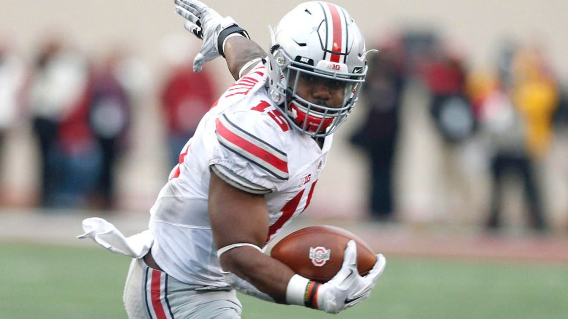 Oct 3, 2015; Bloomington, IN, USA; Ohio State Buckeyes running back Ezekiel Elliott (15) runs with the ball against the Indiana Hoosiers at Memorial Stadium. Ohio State defeats Indiana 34-27. Mandatory Credit: Brian Spurlock-USA TODAY Sports