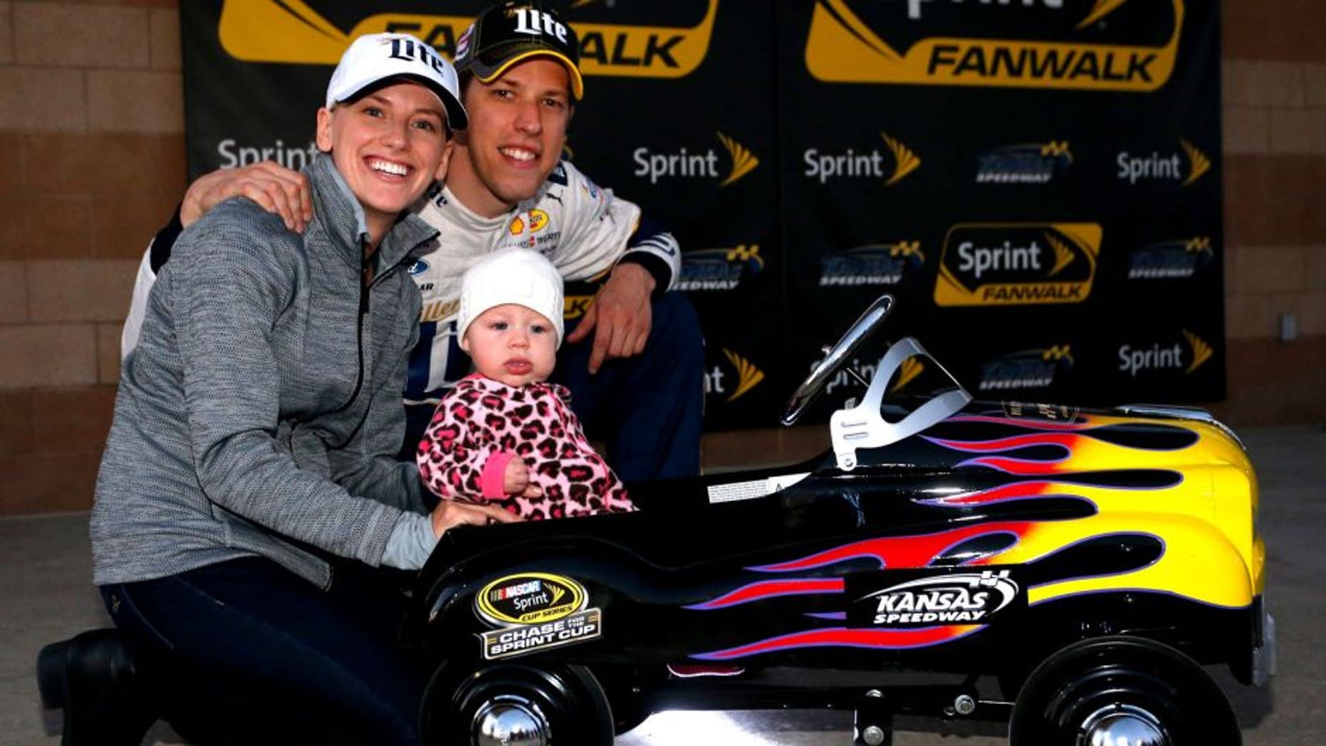 KANSAS CITY, KS - OCTOBER 16: Brad Keselowski, driver of the #2 Miller Lite Ford, poses with his girlfriend Paige White and their daughter Scarlett after Keselowski qualified on the pole for the NASCAR Sprint Cup Series Hollywood Casino 400 at Kansas Speedway on October 16, 2015 in Kansas City, Kansas. (Photo by Brian Lawdermilk/NASCAR via Getty Images)