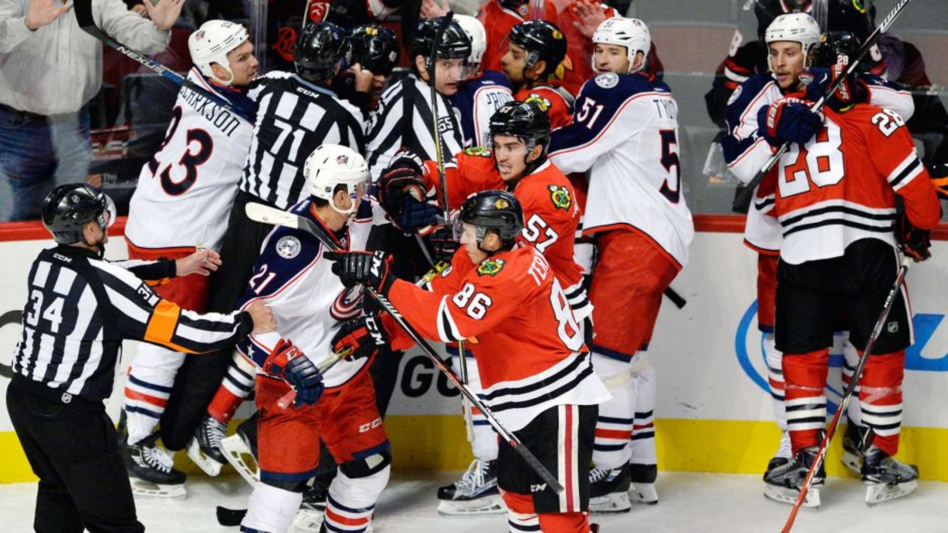 Chicago Blackhawks players scuffle with Columbus Blue Jackets players during the third period of an NHL hockey game Saturday, Oct. 17, 2015, in Chicago. Chicago won 4-1. (AP Photo/Paul Beaty)