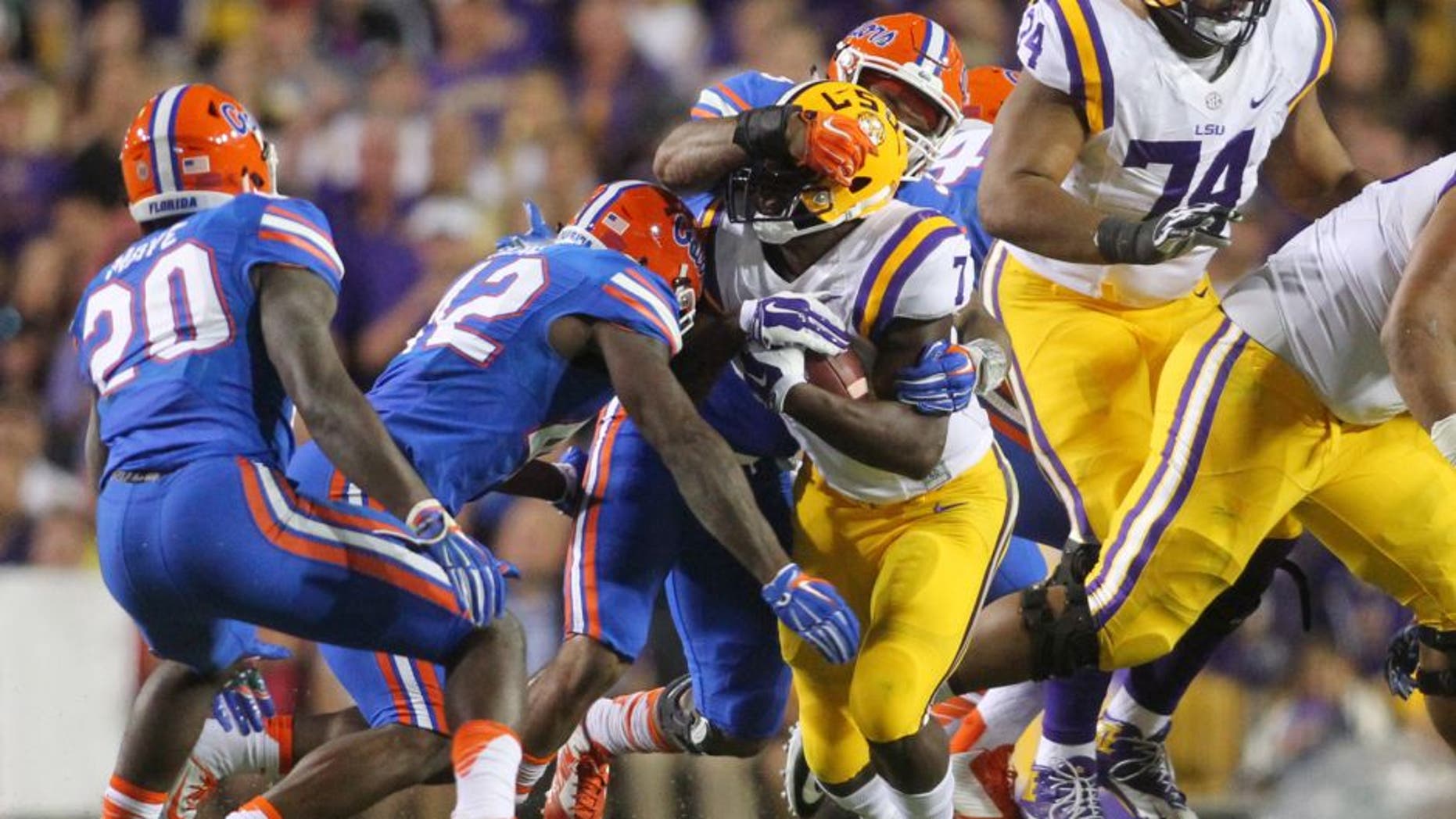 Oct 17, 2015; Baton Rouge, LA, USA; LSU Tigers running back Leonard Fournette (7) is tackled by Florida Gators linebacker Antonio Morrison (3) at Tiger Stadium. Mandatory Credit: Crystal LoGiudice-USA TODAY Sports