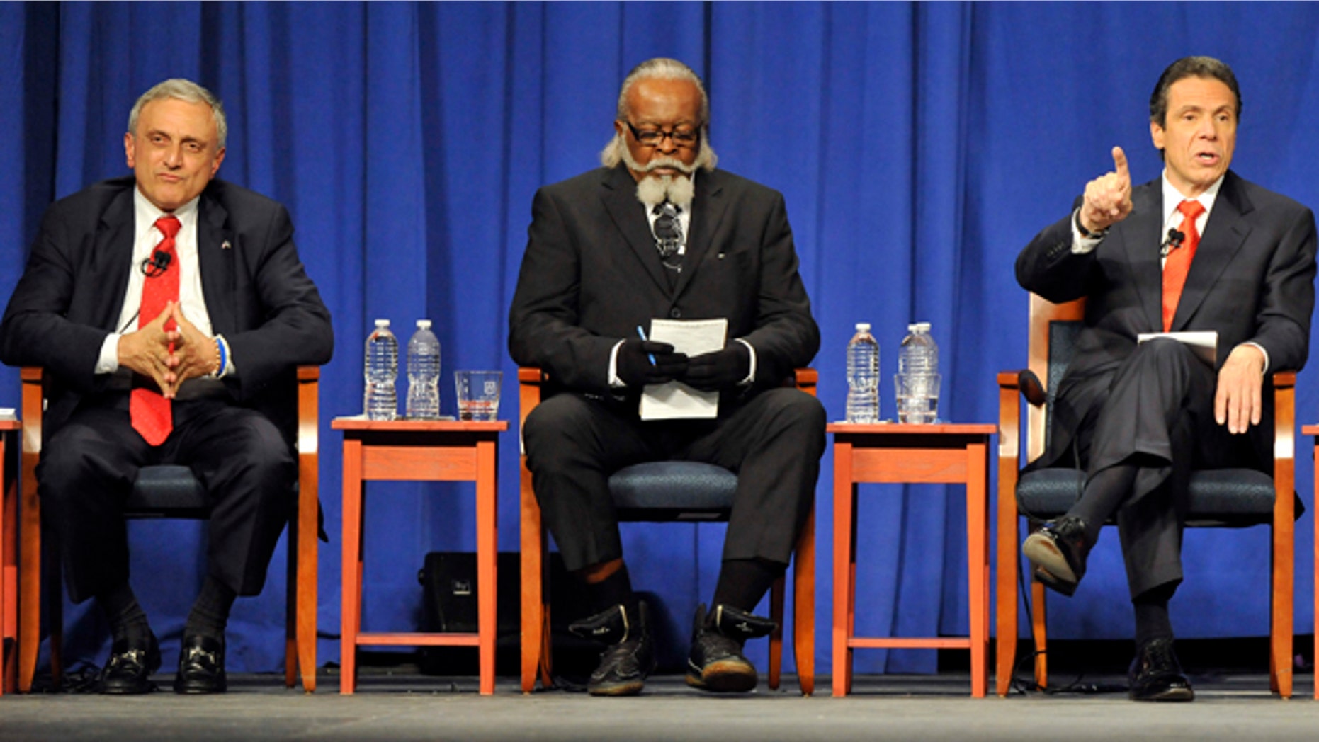 Oct. 18, 2010: Republican candidate Carl Paladino, left, listens with Rent is 2 Damn High candidate Jimmy McMillan as Democratic candidate Andrew Cuomo speaks during the 2010 New York State gubernatorial debate at Hofstra University in Hempstead, N.Y.