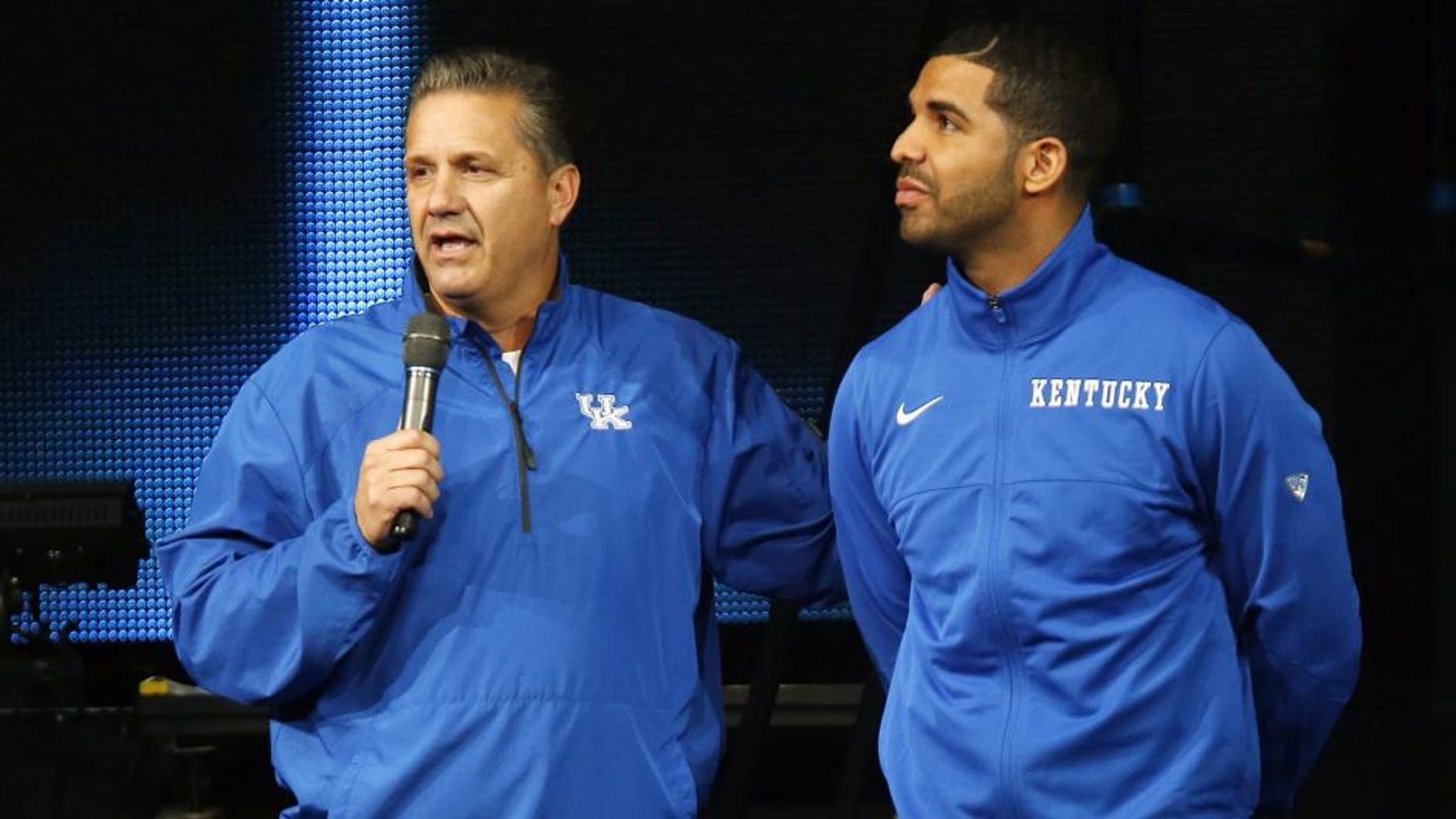 CORRECTS DAY OF WEEK TO FRIDAY - Kentucky coach John Calipari, left, and hip-hop star Drake speak during the team's NCAA college basketball Big Blue Madness, Friday, Oct. 17, 2014, in Lexington, Ky. (AP Photo/James Crisp)