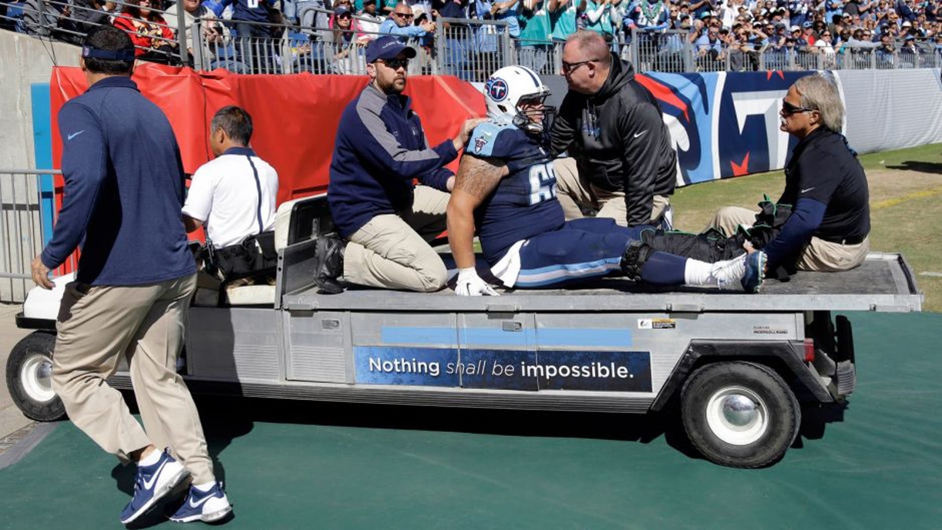 Tennessee Titans center Brian Schwenke (62) is taken off the field after injuring his leg in the first half of an NFL football game against the Miami Dolphins Sunday, Oct. 18, 2015, in Nashville, Tenn. (AP Photo/James Kenney)
