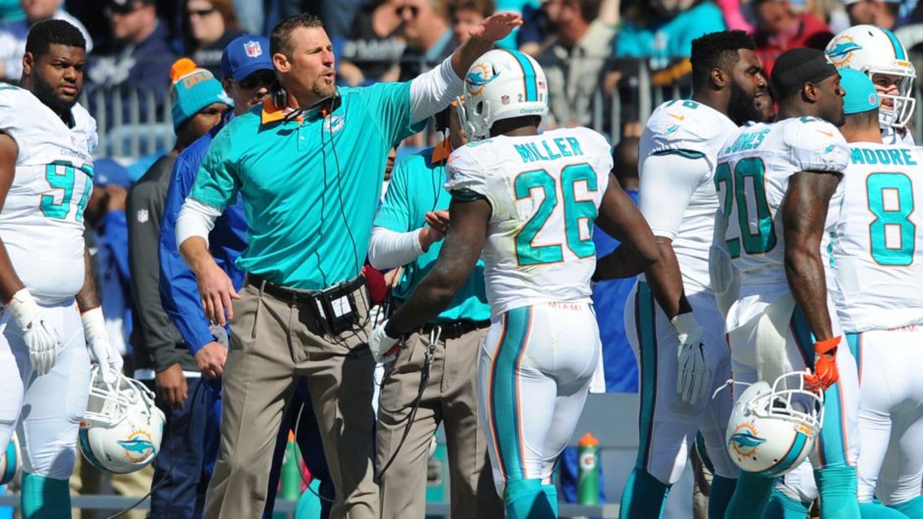 Oct 18, 2015; Nashville, TN, USA; Miami Dolphins interim head coach Dan Campbell (C) celebrates with players after a touchdown during the first half against the Tennessee Titans at Nissan Stadium. Mandatory Credit: Christopher Hanewinckel-USA TODAY Sports