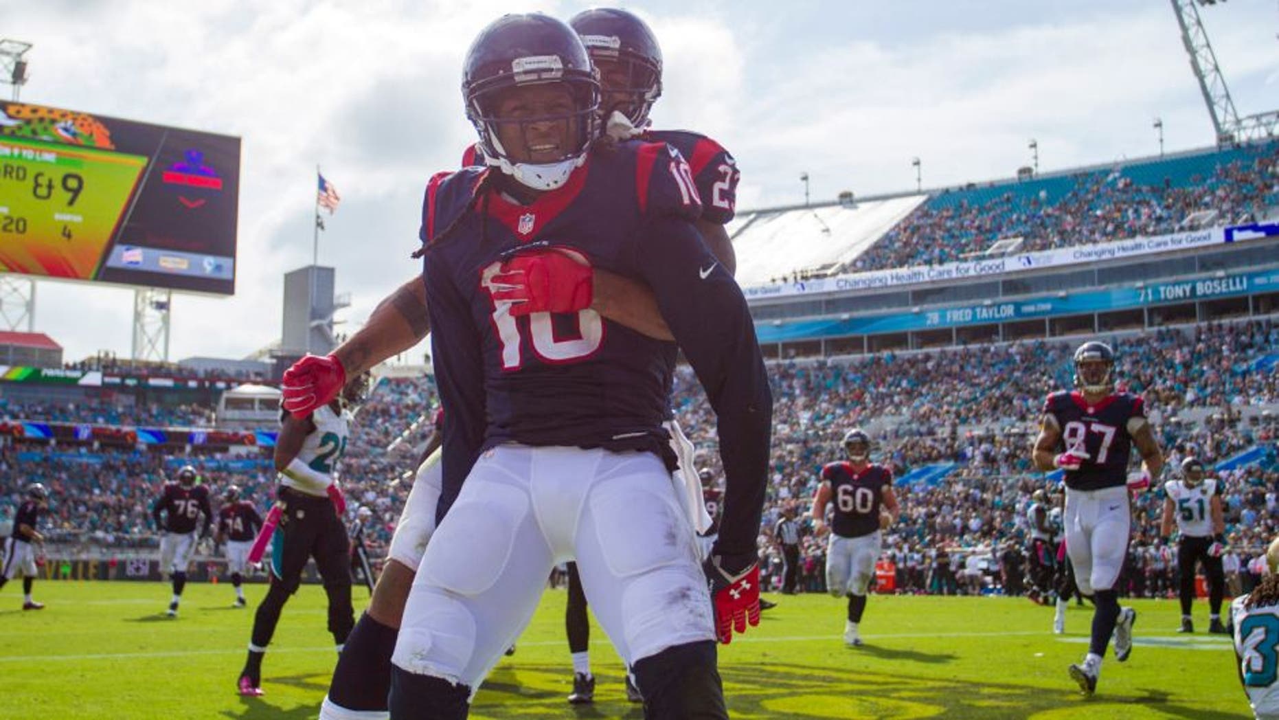 Oct 18, 2015; Jacksonville, FL, USA; Houston Texans running back Arian Foster (behind) celebrates with Houston Texans wide receiver DeAndre Hopkins (10) after a touchdown against the Jacksonville Jaguars at EverBank Field. The Houston Texans won 31-20. Mandatory Credit: Logan Bowles-USA TODAY Sports