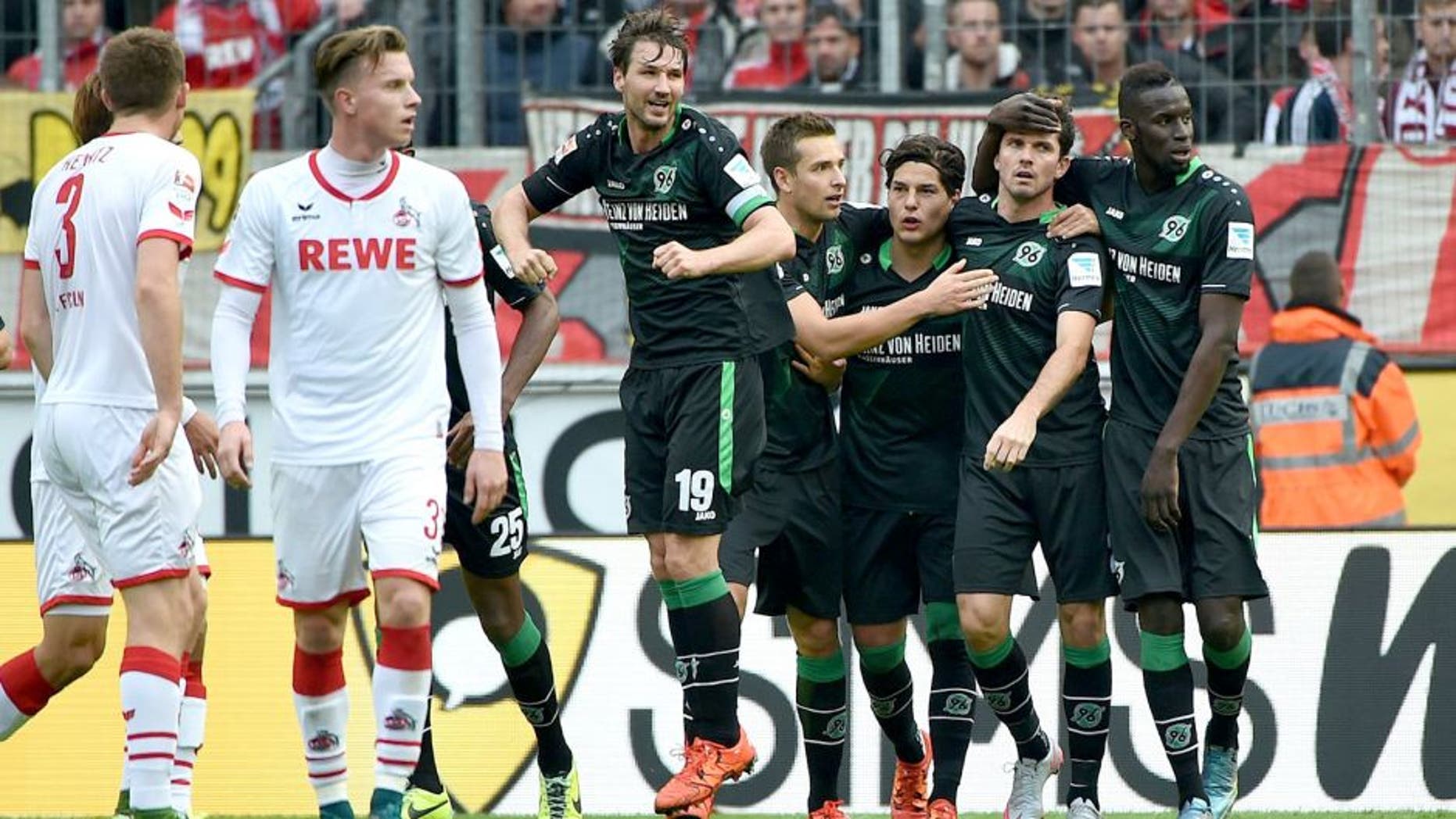 Hannoverôs players celebrate during the German first division Bundesliga football match 1 FC Cologne vs Hanover 96 in Cologne, western Germany, on October 18, 2015. AFP PHOTO / PATRIK STOLLARZ RESTRICTIONS: DURING MATCH TIME: DFL RULES TO LIMIT THE ONLINE USAGE TO 15 PICTURES PER MATCH AND FORBIDS IMAGE SEQUENCES TO SIMULATE VIDEO. == RESTRICTED TO EDITORIAL USE == FOR FURTHER QUERIES PLEASE CONTACT DFL DIRECTLY AT + 49 69 650050. (Photo credit should read PATRIK STOLLARZ/AFP/Getty Images)