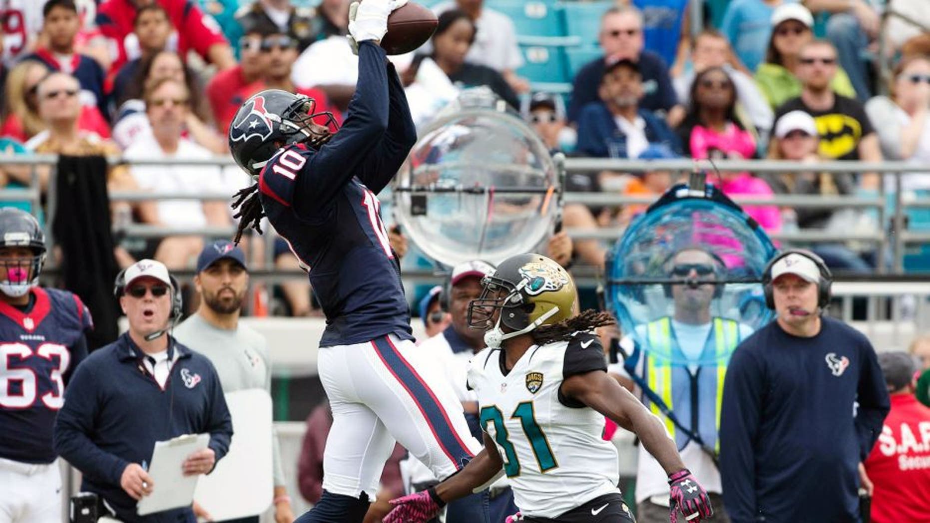 Oct 18, 2015; Jacksonville, FL, USA; Houston Texans wide receiver DeAndre Hopkins (10) makes a catch over Jacksonville Jaguars cornerback Davon House (right) in the second quarter at EverBank Field. Mandatory Credit: Logan Bowles-USA TODAY Sports