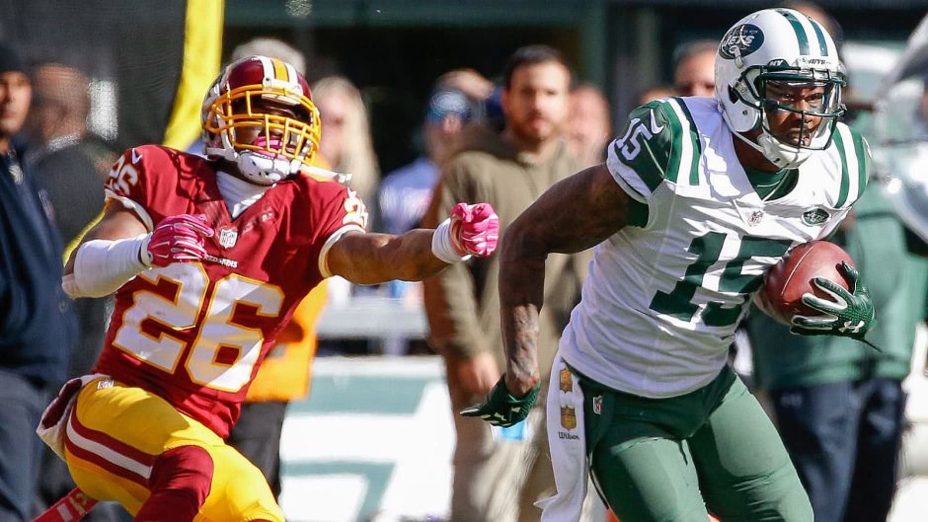 Oct 18, 2015; East Rutherford, NJ, USA; New York Jets wide receiver Brandon Marshall (15) carries the ball past Washington Redskins cornerback Bashaud Breeland (26) in the second half against the Washington Redskins at MetLife Stadium. The Jets won 34-20. Mandatory Credit: Vincent Carchietta-USA TODAY Sports