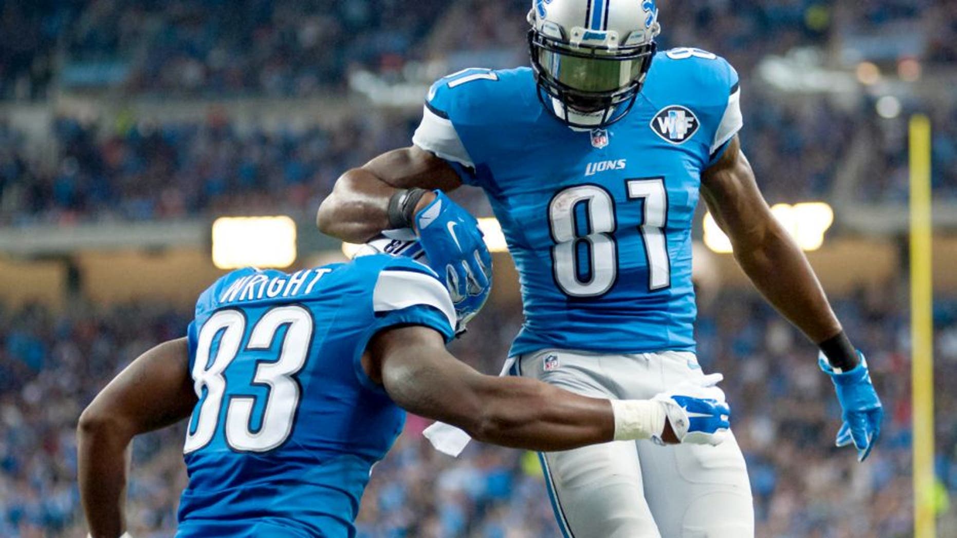 Oct 18, 2015; Detroit, MI, USA; Detroit Lions tight end Timothy Wright (83) celebrates his touchdown with wide receiver Calvin Johnson (81) during the second quarter against the Chicago Bears at Ford Field. Mandatory Credit: Tim Fuller-USA TODAY Sports