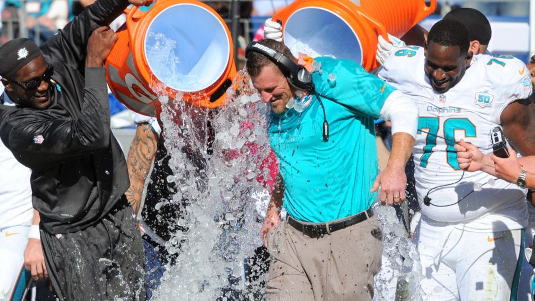 Oct 18, 2015; Nashville, TN, USA; Miami Dolphins interim head coach Dan Campbell is dumped with Gatorade after a win against the Tennessee Titans at Nissan Stadium. The Dolphins won 38-10. Mandatory Credit: Christopher Hanewinckel-USA TODAY Sports