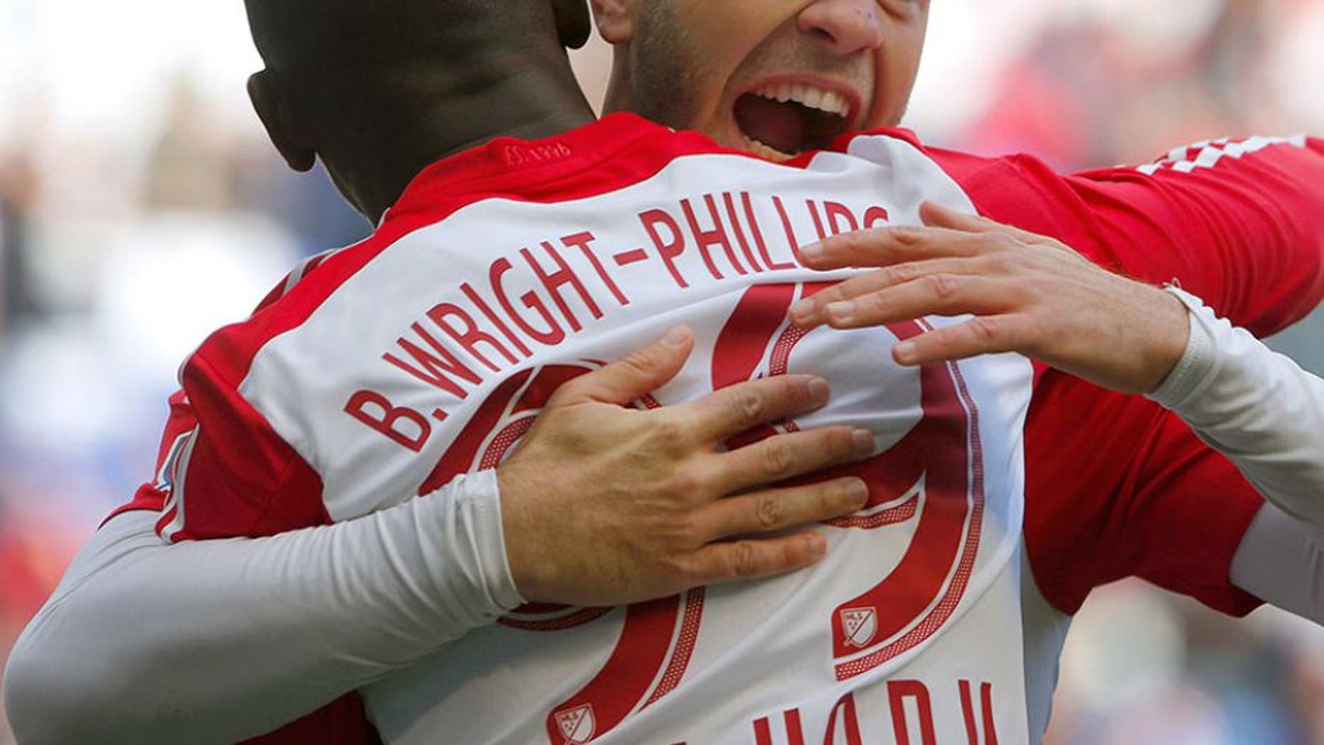 Oct 18, 2015; Harrison, NJ, USA; New York Red Bulls forward Mike Grella (13) hugs New York Red Bulls forward Bradley Wright-Phillips (99) after he scored a goal during first half against Philadelphia Union at Red Bull Arena. Mandatory Credit: Noah K. Murray-USA TODAY Sports