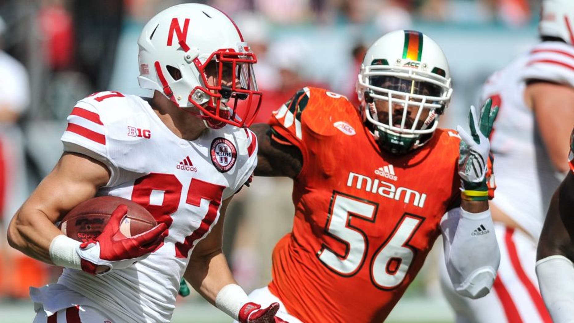 Sep 19, 2015; Miami Gardens, FL, USA; Nebraska Cornhuskers wide receiver Brandon Reilly (87) runs against Miami Hurricanes linebacker Raphael Kirby (56) during the first half at Sun Life Stadium. Mandatory Credit: Steve Mitchell-USA TODAY Sports