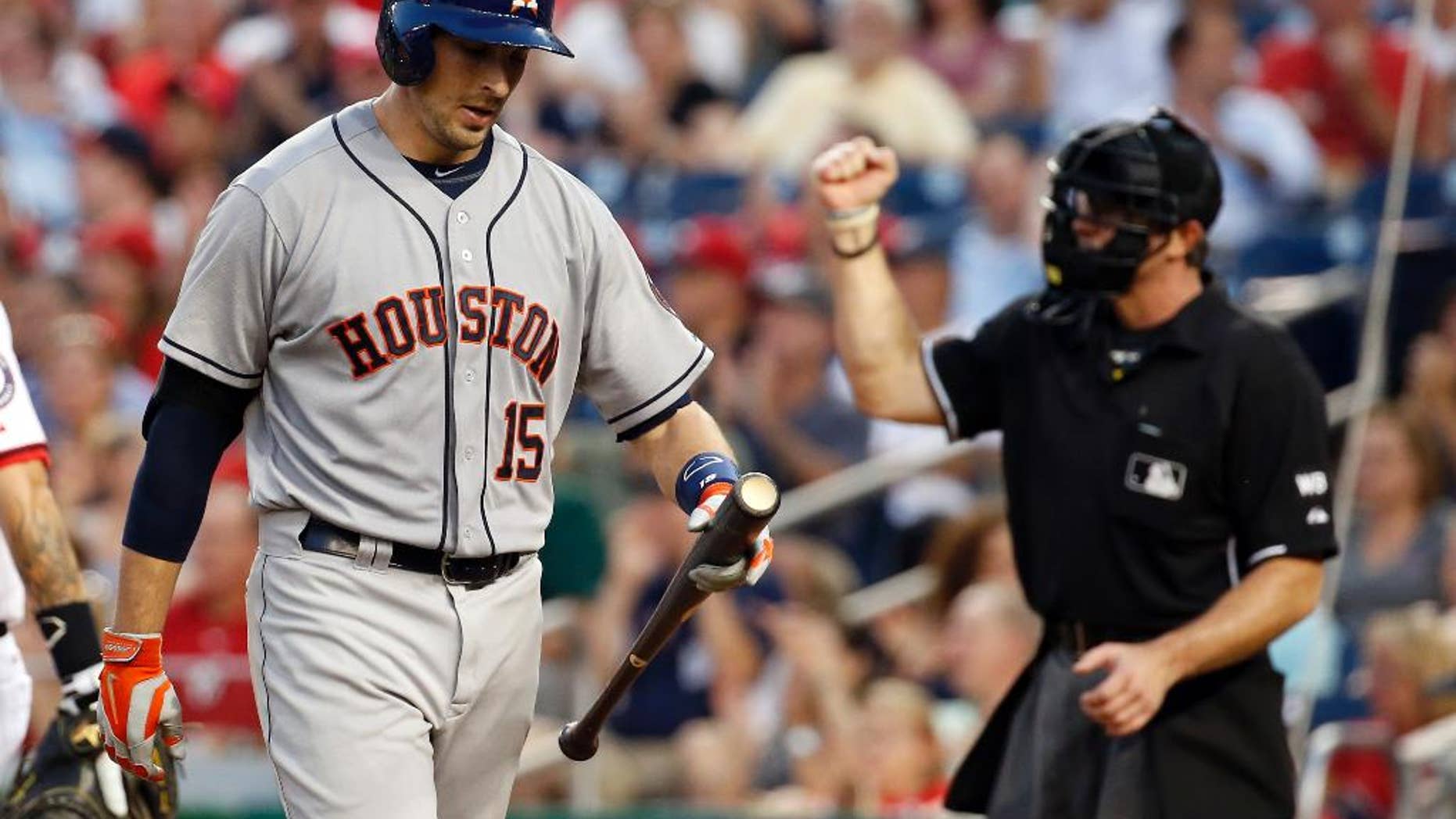 Houston Astros' Jason Castro walks away after striking out with the bases loaded during the fourth inning of an interleague baseball game against the Washington Nationals at Nationals Park Tuesday, June 17, 2014, in Washington. (AP Photo/Alex Brandon)