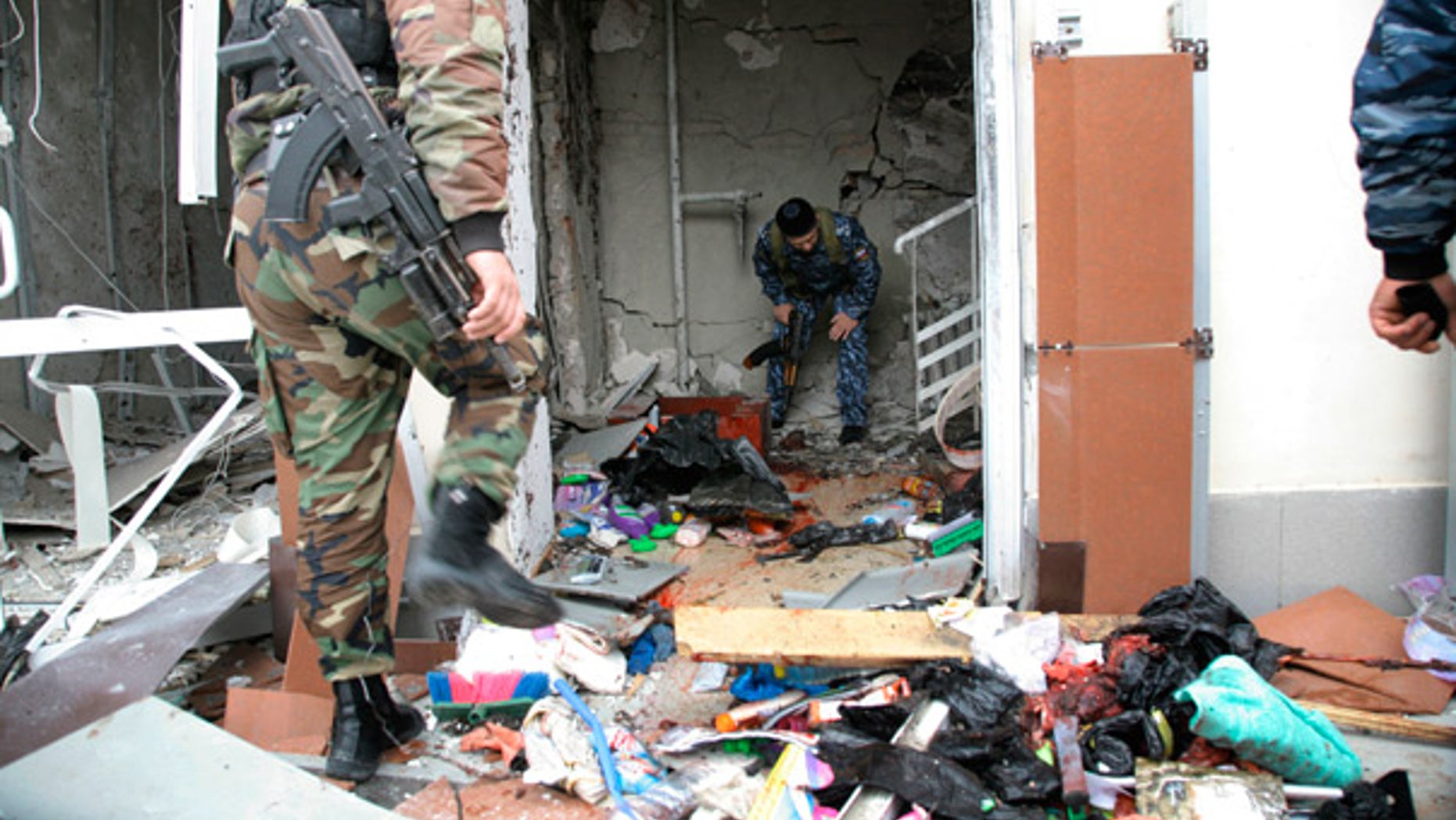 Oct. 19: Special Force officers investigate the scene after a bomb blast in front of the Chechen parliament complex in Grozny.