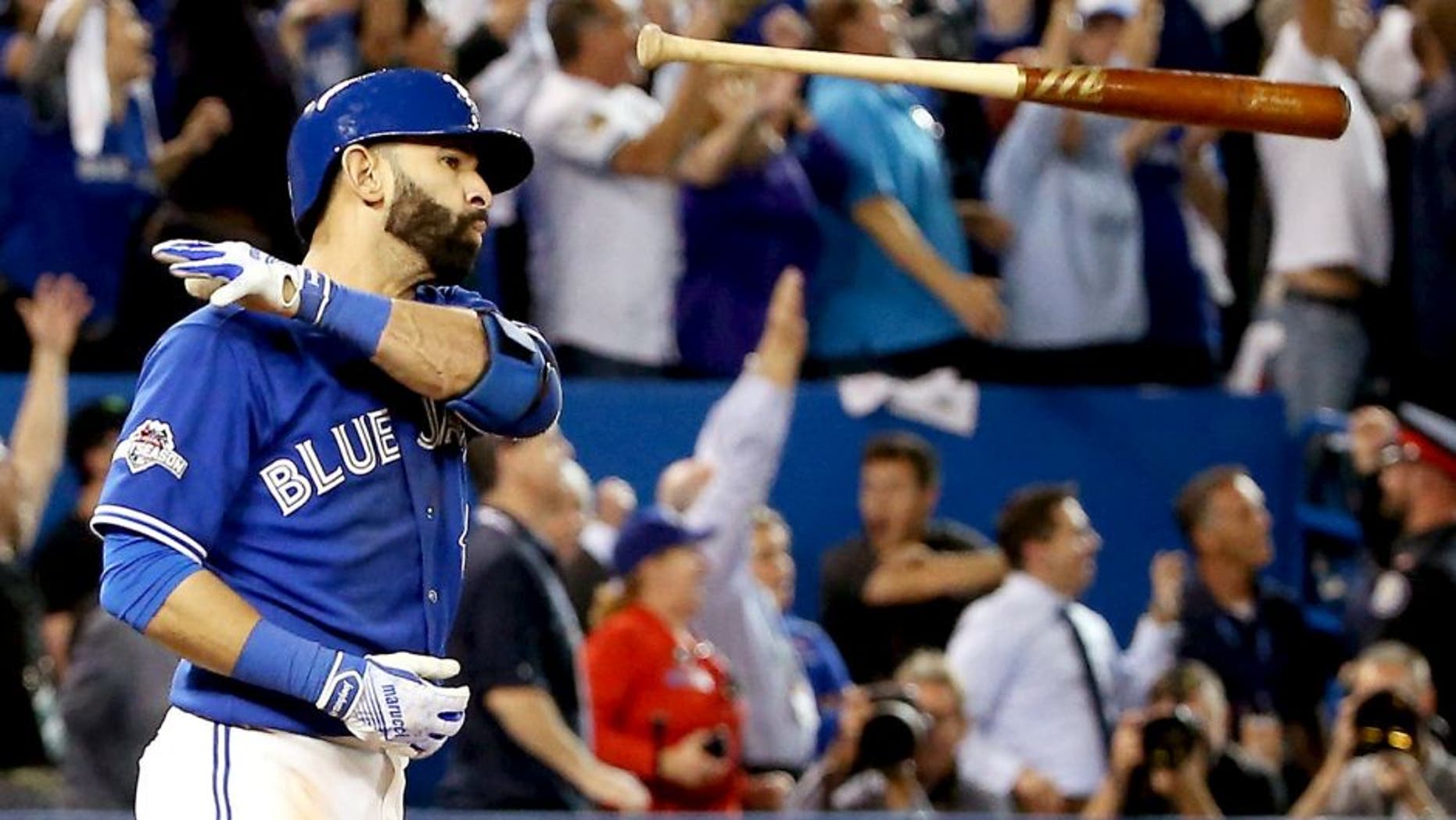 TORONTO, ON - OCTOBER 14: Jose Bautista #19 of the Toronto Blue Jays flips his bat up in the air after he hits a three-run home run in the seventh inning against the Texas Rangers in game five of the American League Division Series at Rogers Centre on October 14, 2015 in Toronto, Canada. (Photo by Tom Szczerbowski/Getty Images)