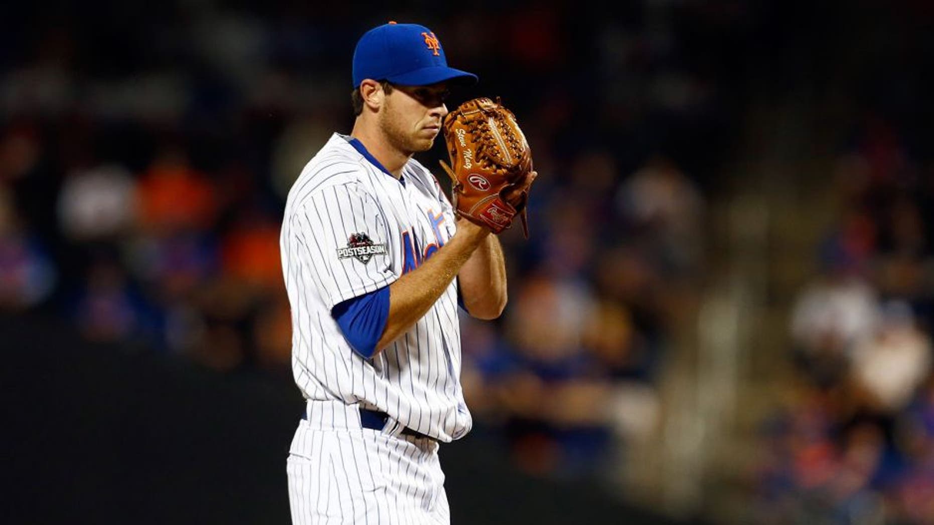 NEW YORK, NY - OCTOBER 13: Steven Matz #32 of the New York Mets prepares to throw a pitch in the first inning against the Los Angeles Dodgers during game four of the National League Division Series at Citi Field on October 13, 2015 in New York City. (Photo by Mike Stobe/Getty Images)