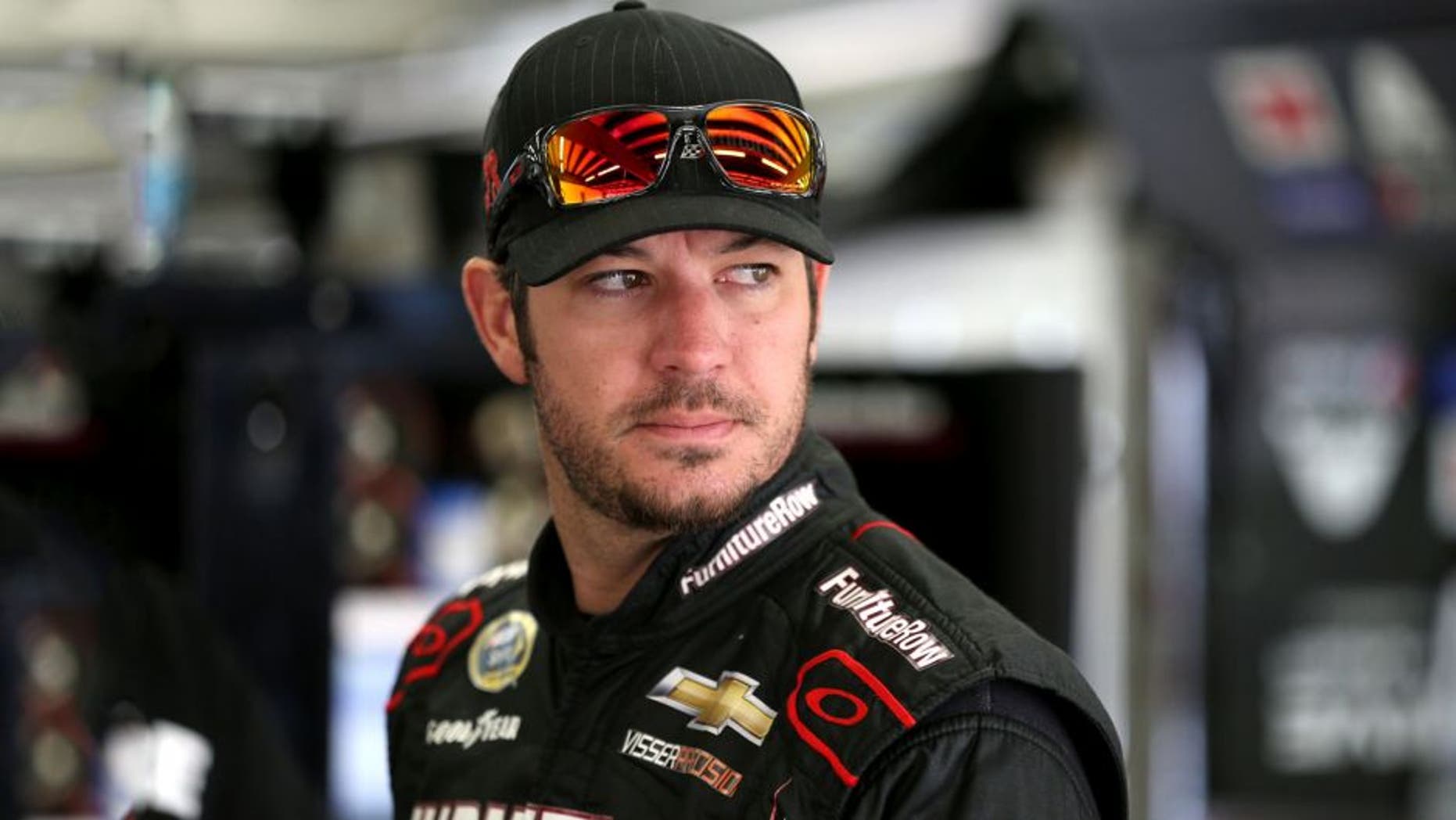 LOUDON, NH - SEPTEMBER 25: Martin Truex Jr., driver of the #78 Furniture Row/Visser Precision Chevrolet, stands in the garage area during practice for the NASCAR Sprint Cup Series Sylvania 300 at New Hampshire Motor Speedway on September 25, 2015 in Loudon, New Hampshire. (Photo by Todd Warshaw/NASCAR via Getty Images)