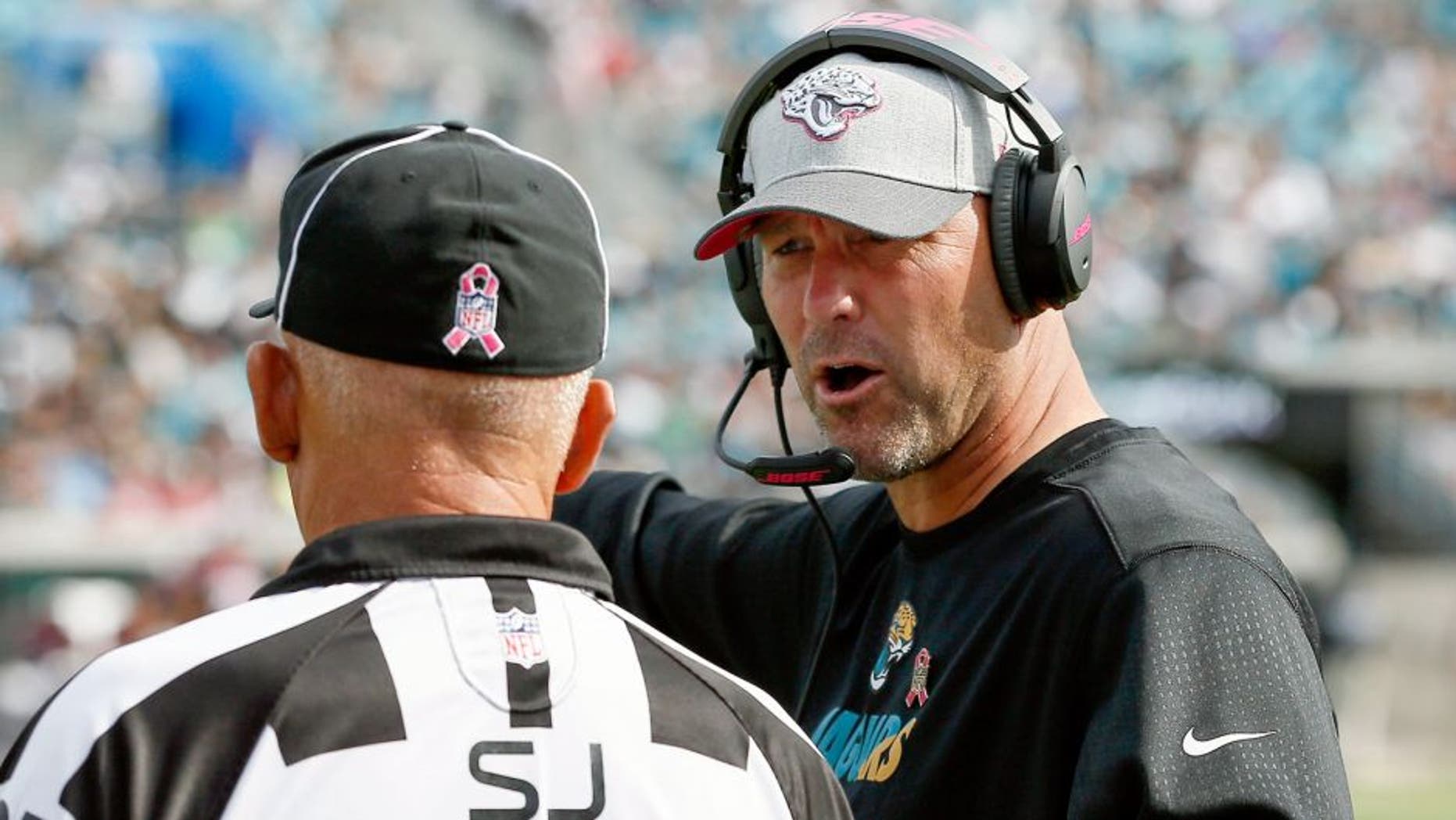 Oct 18, 2015; Jacksonville, FL, USA; side judge Tom Hill (97) listens as Jacksonville Jaguars head coach Gus Bradley complains about a call during the second half of a football game at EverBank Field. Houston won 31-20. Mandatory Credit: Reinhold Matay-USA TODAY Sports
