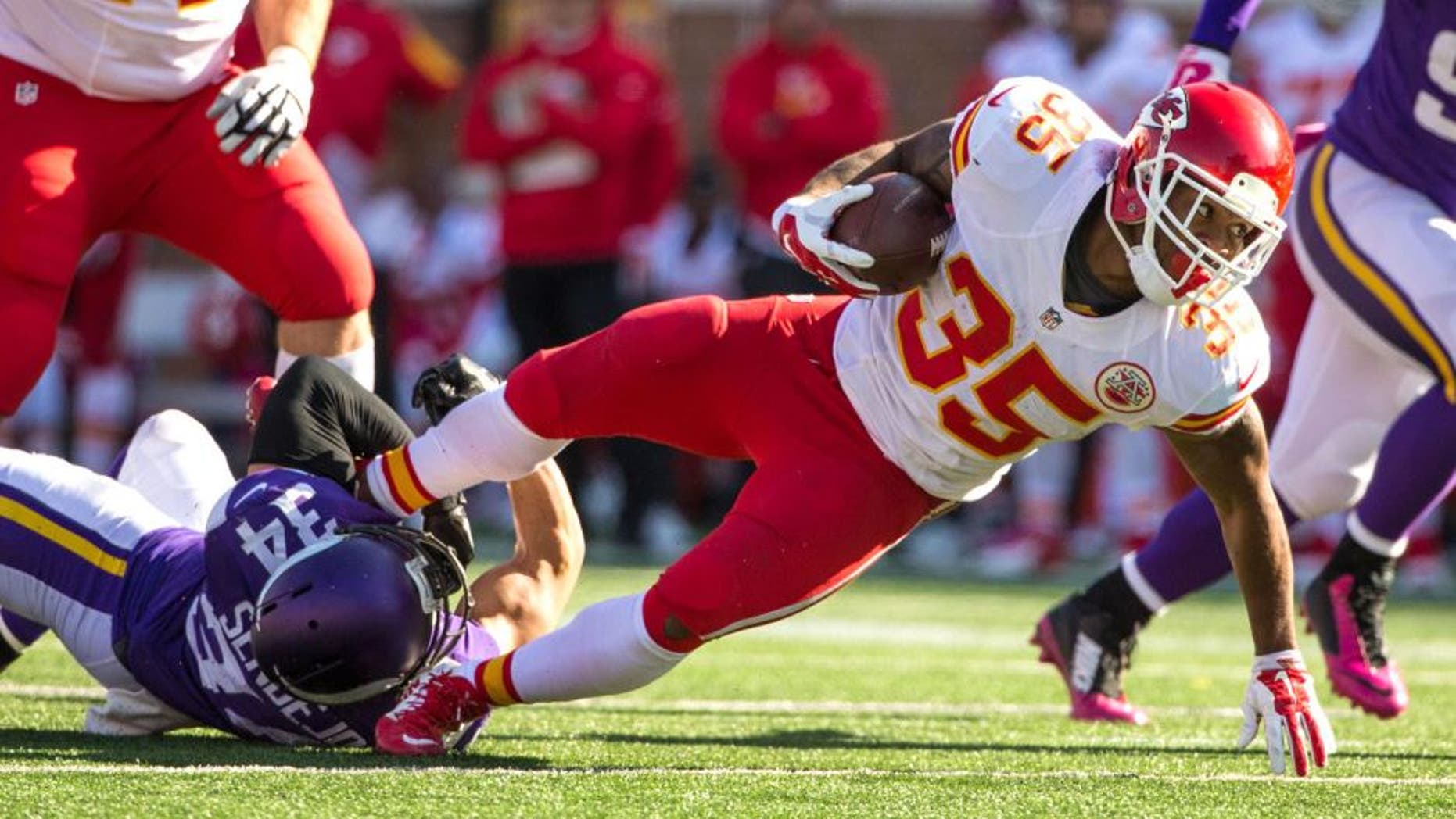 Oct 18, 2015; Minneapolis, MN, USA; Kansas City Chiefs running back Charcandrick West (35) is tackled by Minnesota Vikings safety Andrew Sendejo (34) during the fourth quarter at TCF Bank Stadium. The Vikings defeated the Chiefs 16-10. Mandatory Credit: Brace Hemmelgarn-USA TODAY Sports