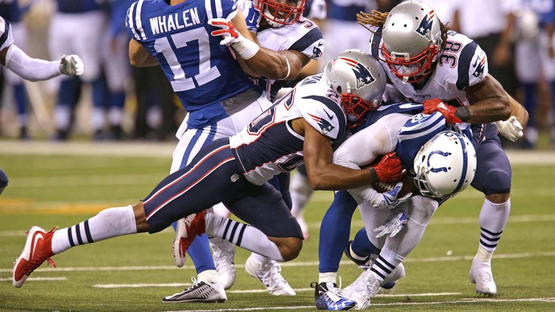 INDIANAPOLIS - OCTOBER 18: New England Patriots Brandon Bolden and New England Patriots defense weren't fooled when the Indianapolis Colts lined up in a strange punt formation as Bolden and cornerback Logan Ryan grabbed Indianapolis Colts Colt Anderson and took him to the turf on the play in the third quarter. The New England Patriots take on the Indianapolis Colts in a Sunday night football game at Lucas Oil Stadium in Indianapolis, Ind. on Oct. 18, 2015. (Photo by Barry Chin/The Boston Globe via Getty Images)