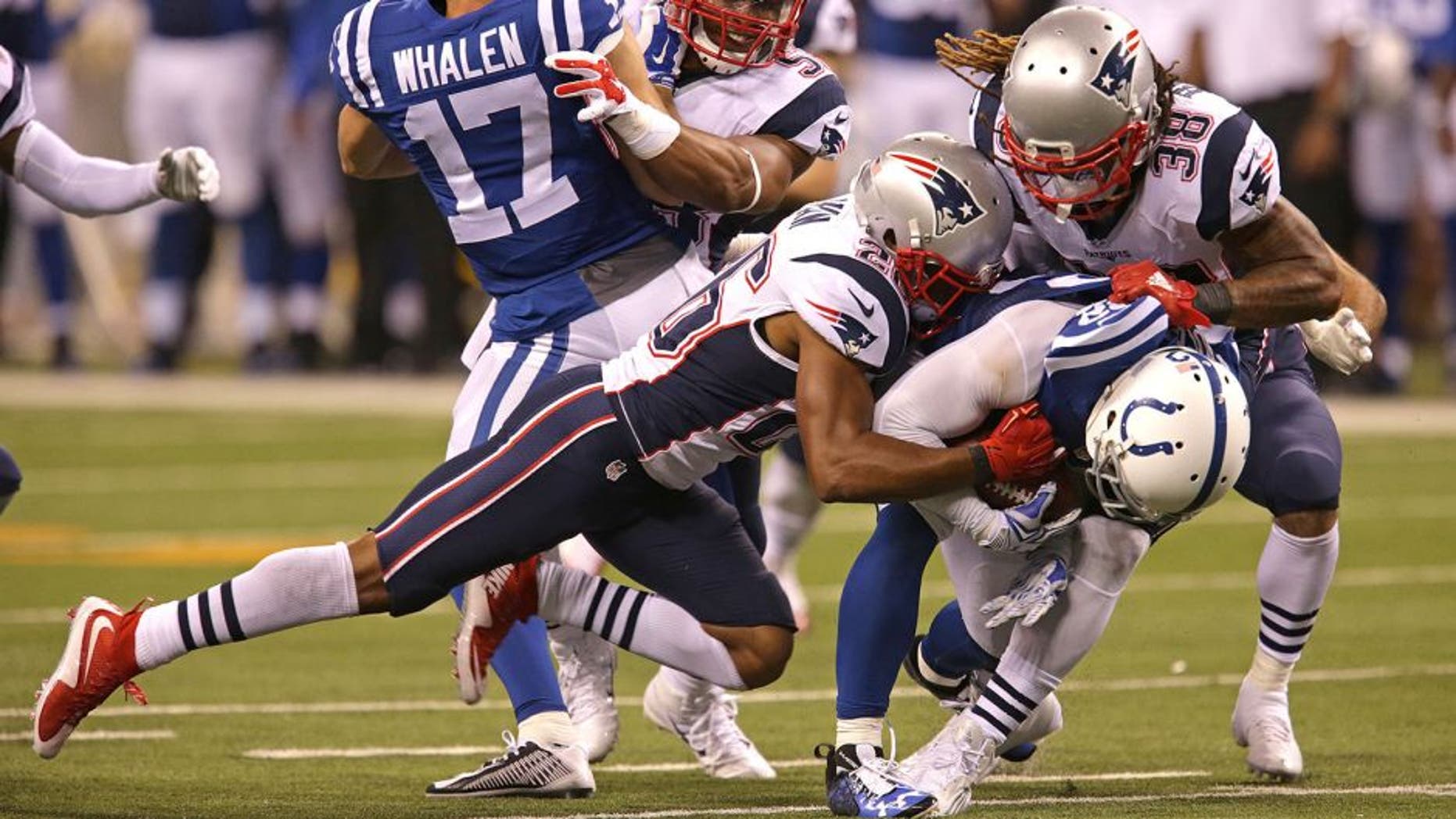 INDIANAPOLIS - OCTOBER 18: New England Patriots Brandon Bolden and New England Patriots defense weren't fooled when the Indianapolis Colts lined up in a strange punt formation as Bolden and cornerback Logan Ryan grabbed Indianapolis Colts Colt Anderson and took him to the turf on the play in the third quarter. The New England Patriots take on the Indianapolis Colts in a Sunday night football game at Lucas Oil Stadium in Indianapolis, Ind. on Oct. 18, 2015. (Photo by Barry Chin/The Boston Globe via Getty Images)