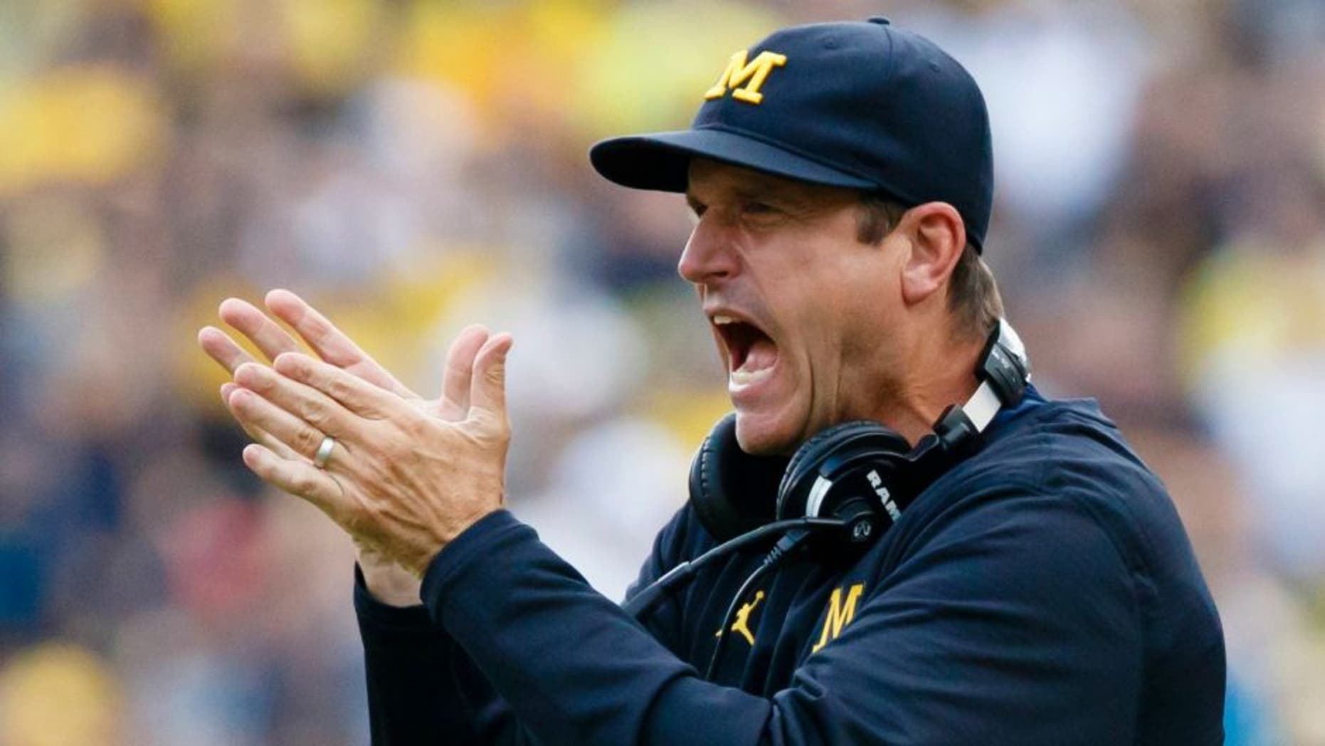 Sep 10, 2016; Ann Arbor, MI, USA; Michigan Wolverines head coach Jim Harbaugh claps after a touchdown in the second half against the UCF Knights at Michigan Stadium. Michigan won 51-14. Mandatory Credit: Rick Osentoski-USA TODAY Sports
