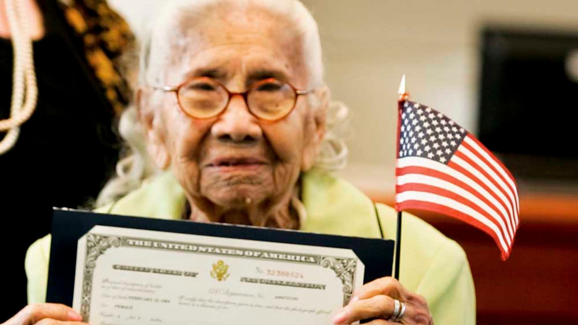 Eulalia Garcia-Maturey, 101, poses with her certificate of naturalization after her naturalization ceremony in Brownsville, Texas, Tuesday, Oct. 12, 2010. Garcia-Maturey became a naturalized U.S. citizen on Tuesday, exactly 101 years after arriving in the U.S. with her parents from Mexico. (AP Photo/The Brownsville Herald, Yvette Vela)